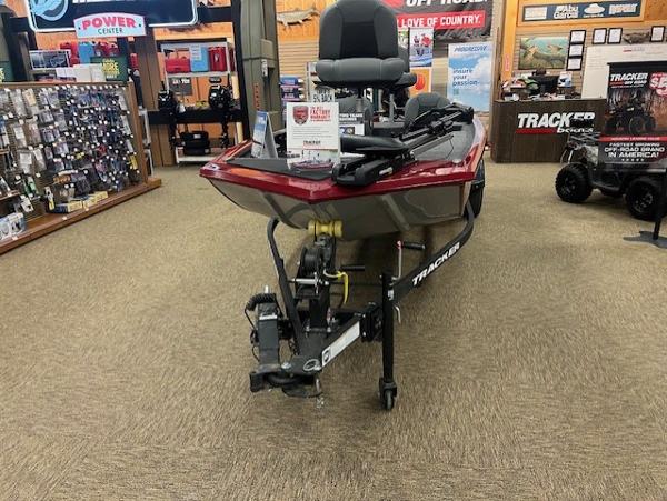 2025 Tracker Pro 170 boat displayed in a showroom with fishing gear.