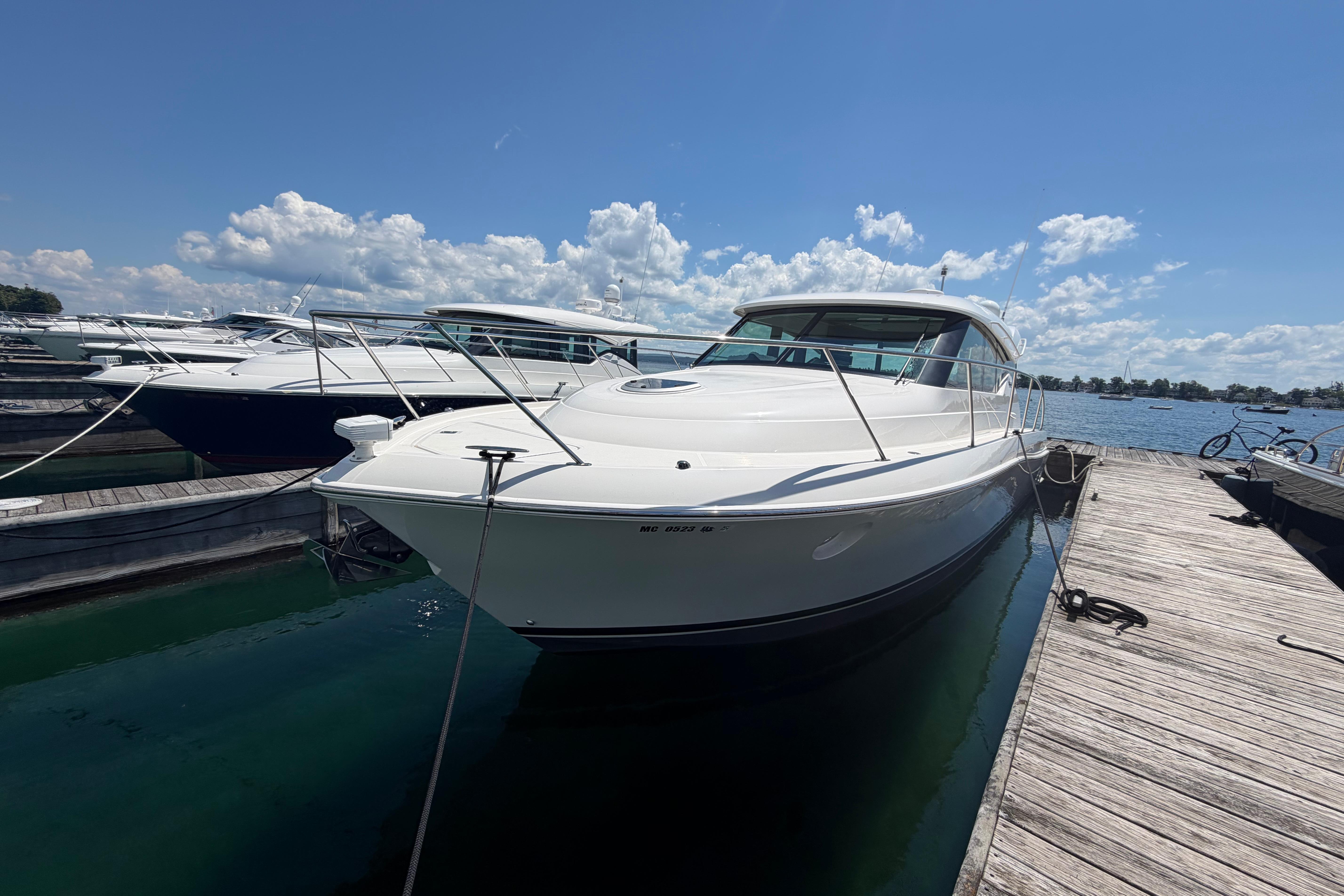 2016 Tiara Yachts C39 Coupe docked at marina under clear blue sky.