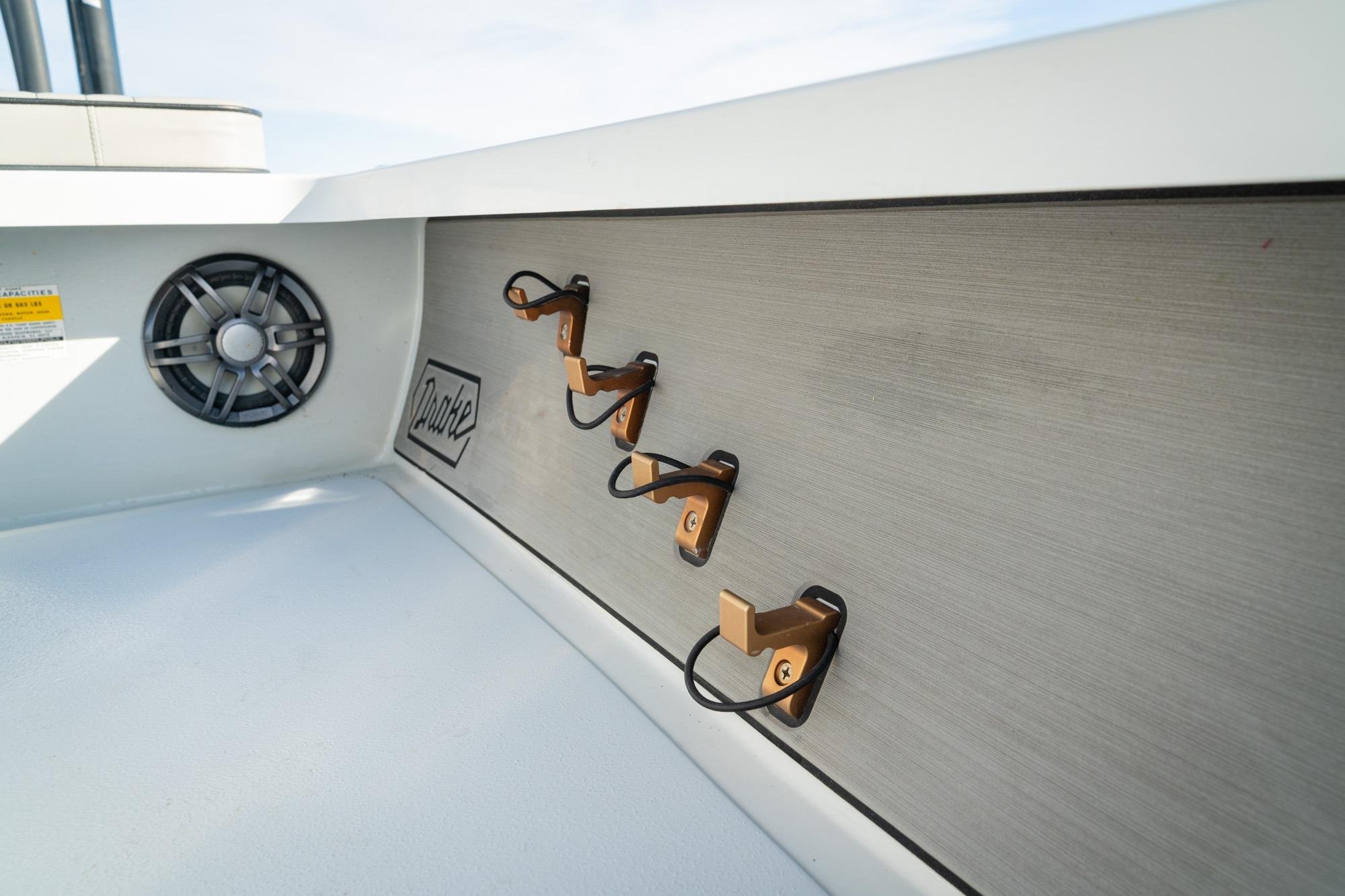 2021 Drake Nomad boat interior with speaker and hooks on a sleek panel.