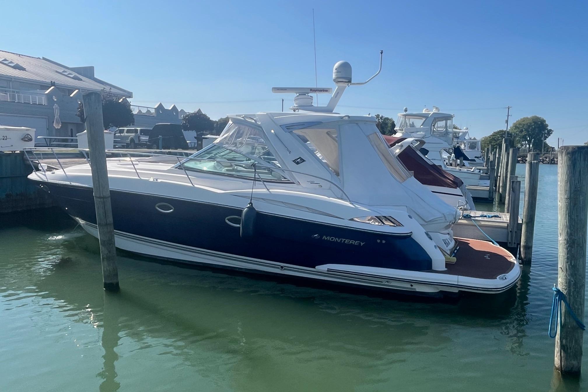 2010 Monterey 400 Sport Yacht docked in a marina under clear blue skies.