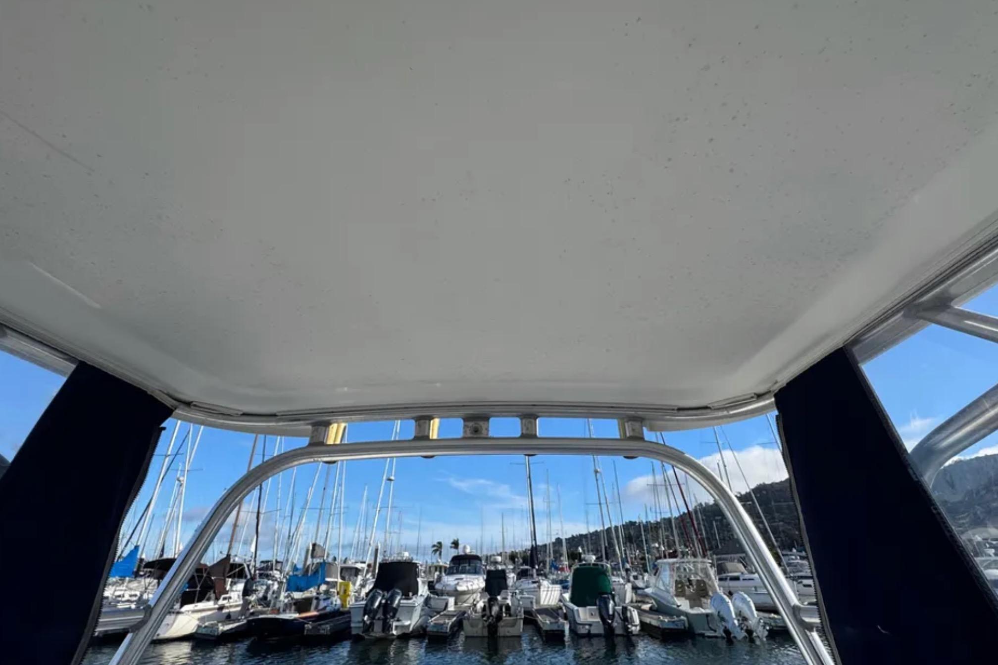 View from a 2004 Boston Whaler 255 Conquest, overlooking a marina with docked boats.