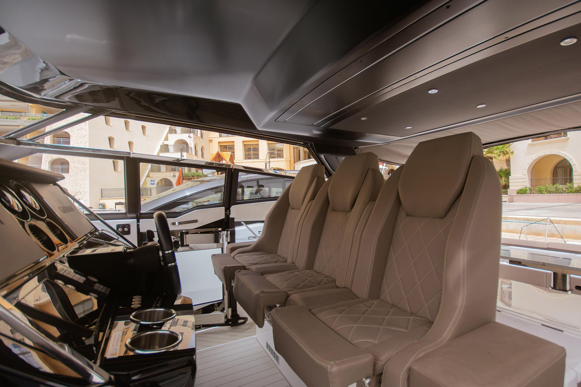 Luxurious interior of 2024 Sunseeker Superhawk 55 yacht with plush seating and sleek design.