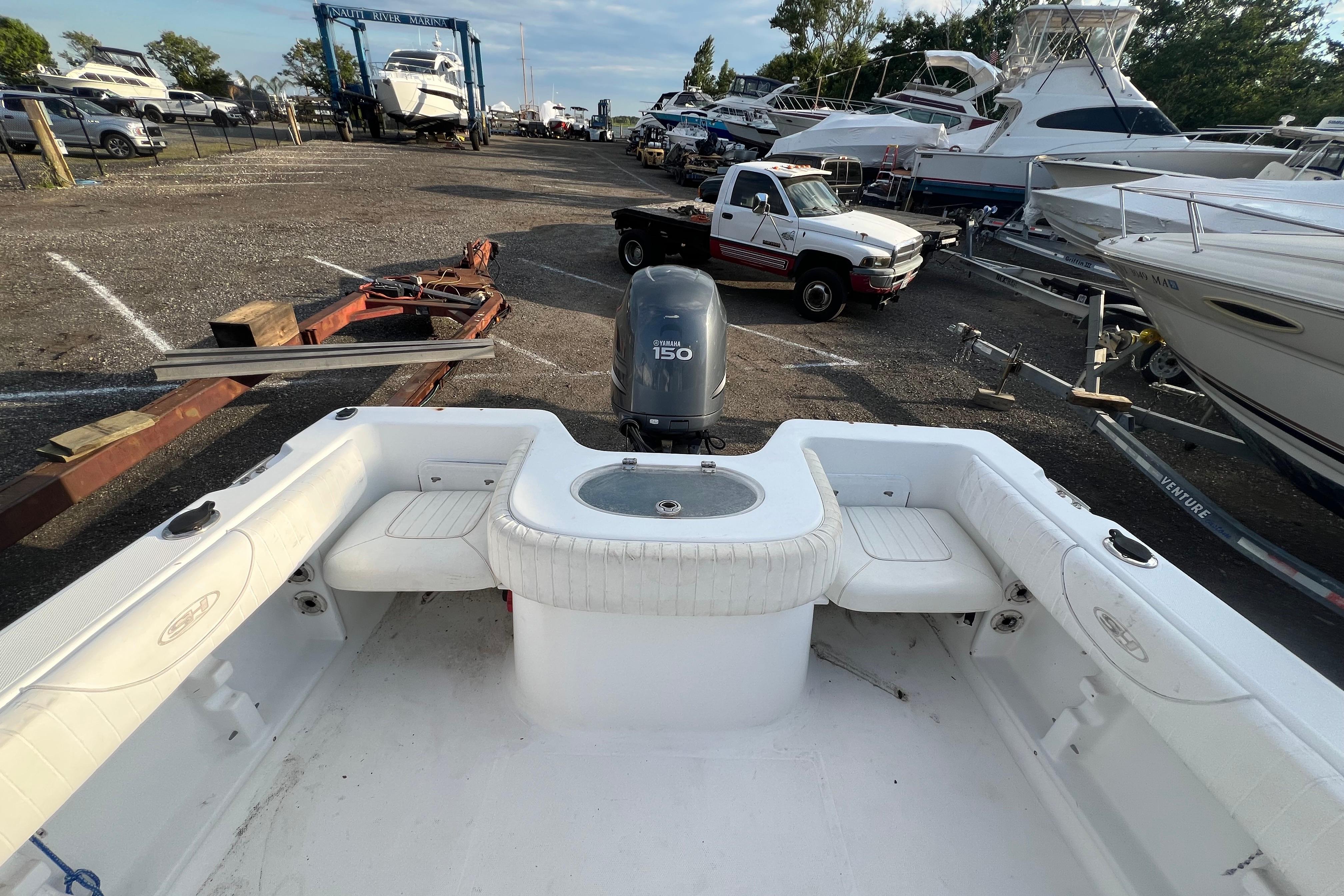 2008 Sea Hunt Victory 207 boat with Yamaha 150 engine in a marina setting.