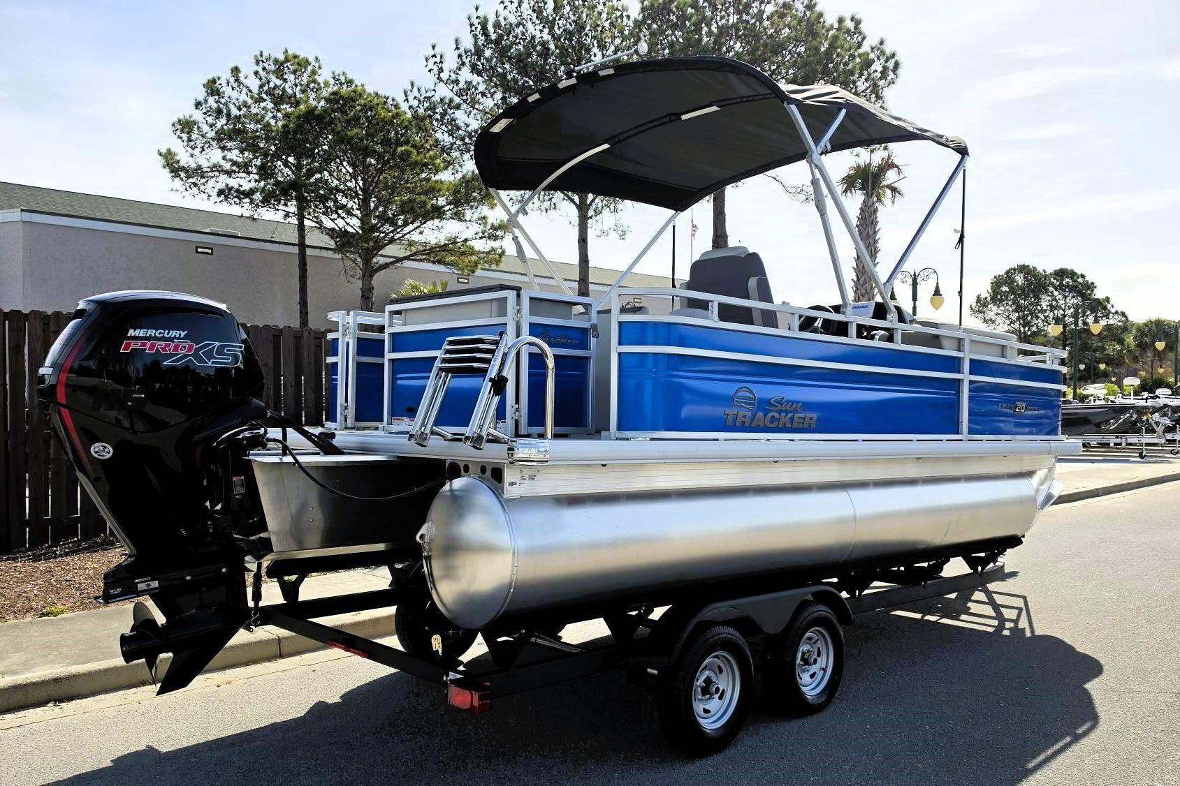 2026 Sun Tracker Fishin' Barge 20 DLX pontoon boat with Mercury Pro XS engine.