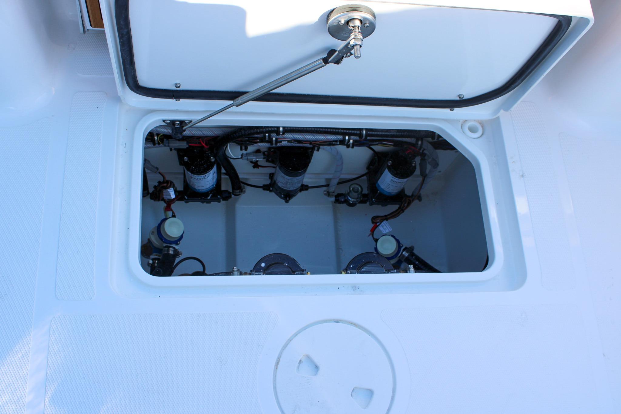 2026 Sea Hunt Gamefish 25 boat compartment with visible mechanical components.