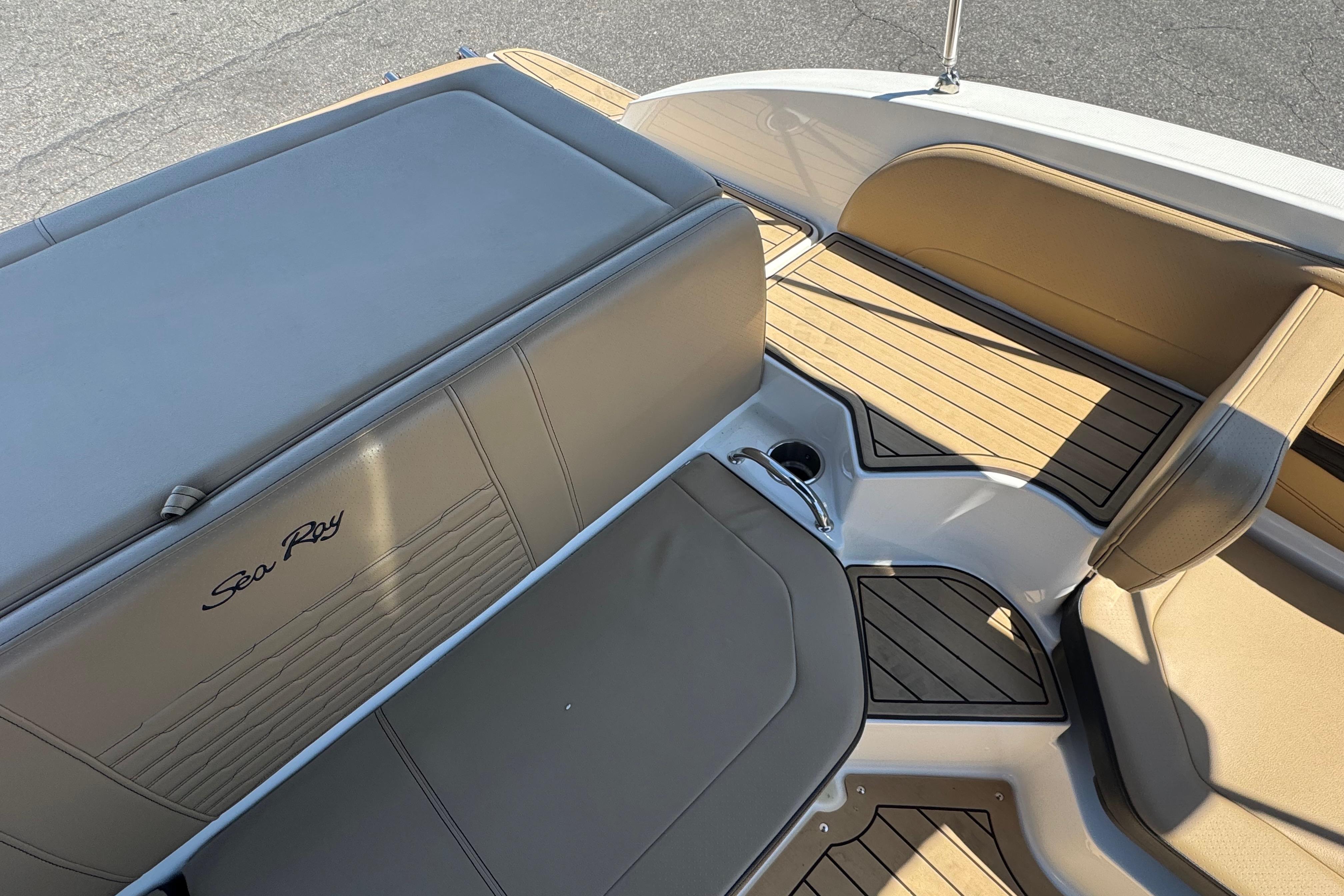 2021 Sea Ray SPX 190 boat interior with tan seating and wood-style flooring.
