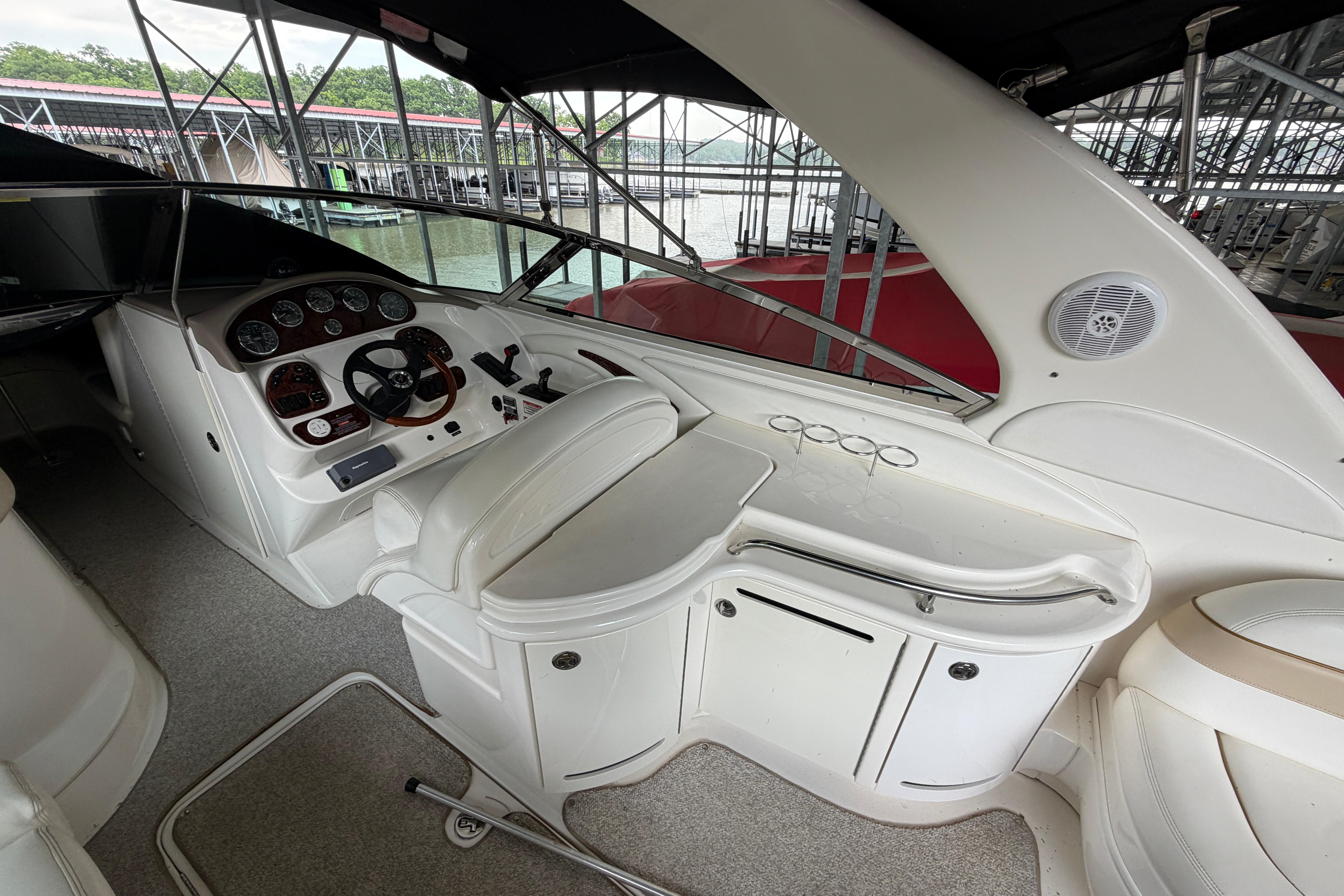 2003 Sea Ray 290 Bowrider interior with helm, seating, and control panel.