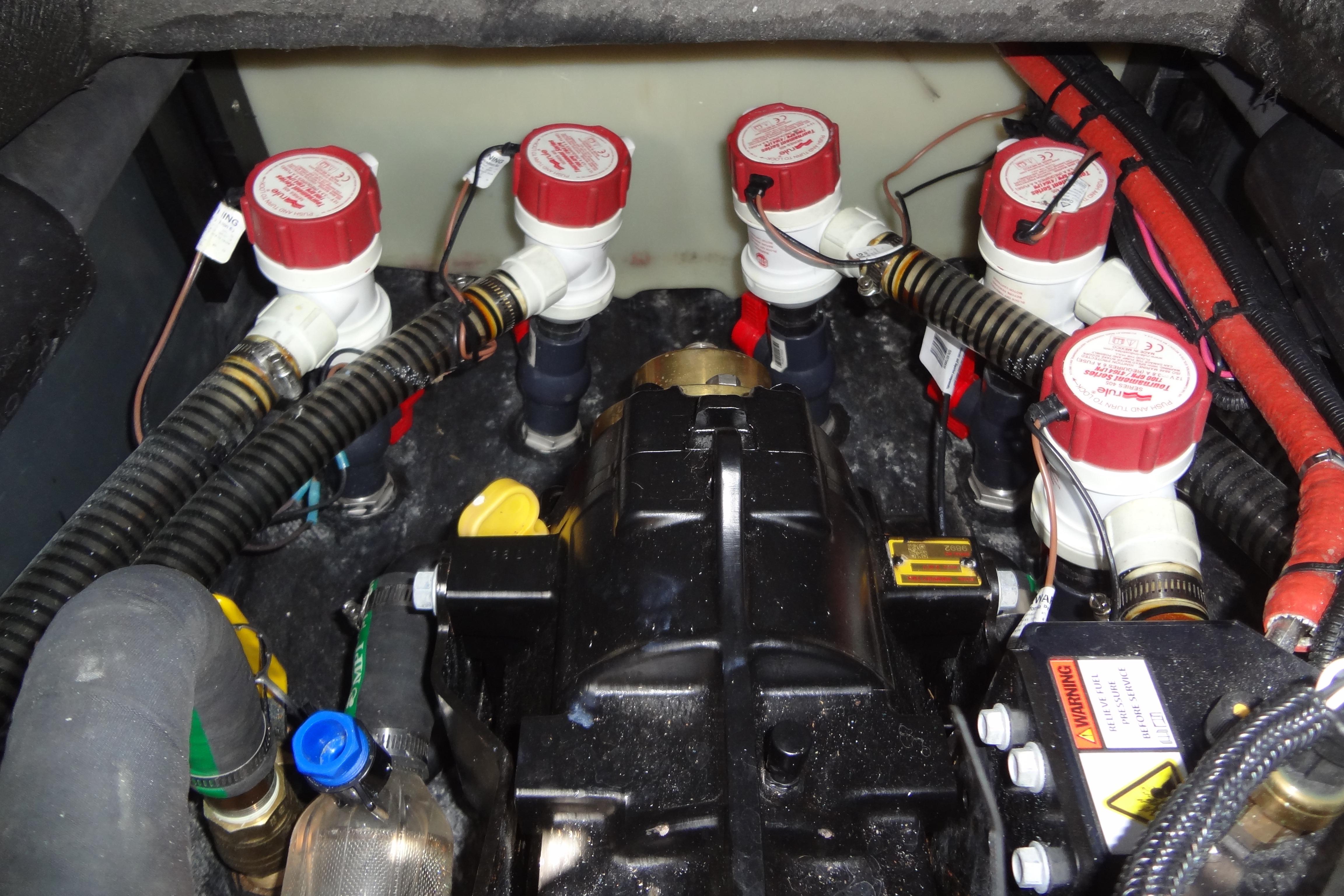Engine compartment of 2022 ATX Surf Boats 24 Type-S, featuring multiple valves and hoses.