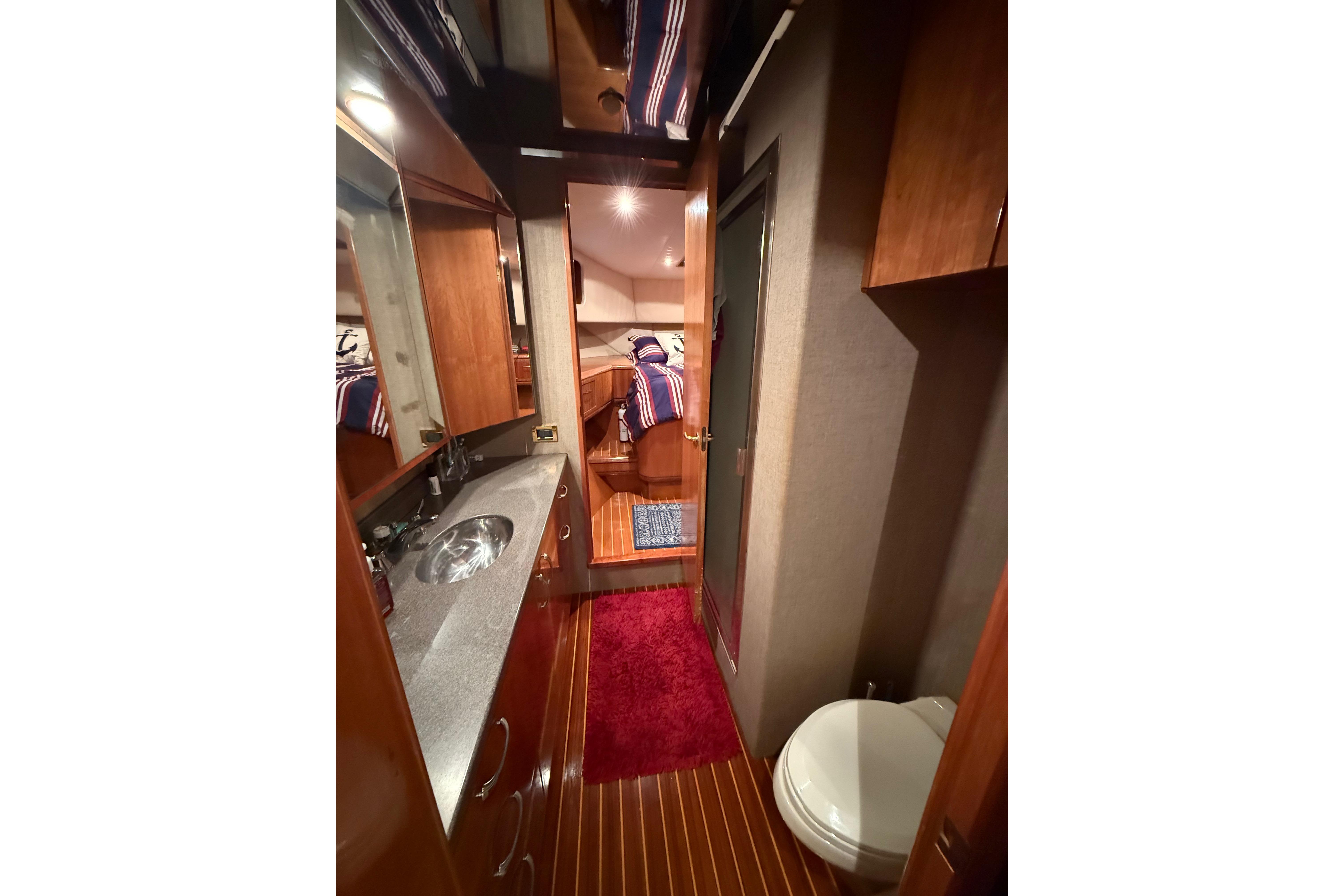Luxurious 2000 Northern Pacific Motor Yacht interior with wood finishes and modern amenities.