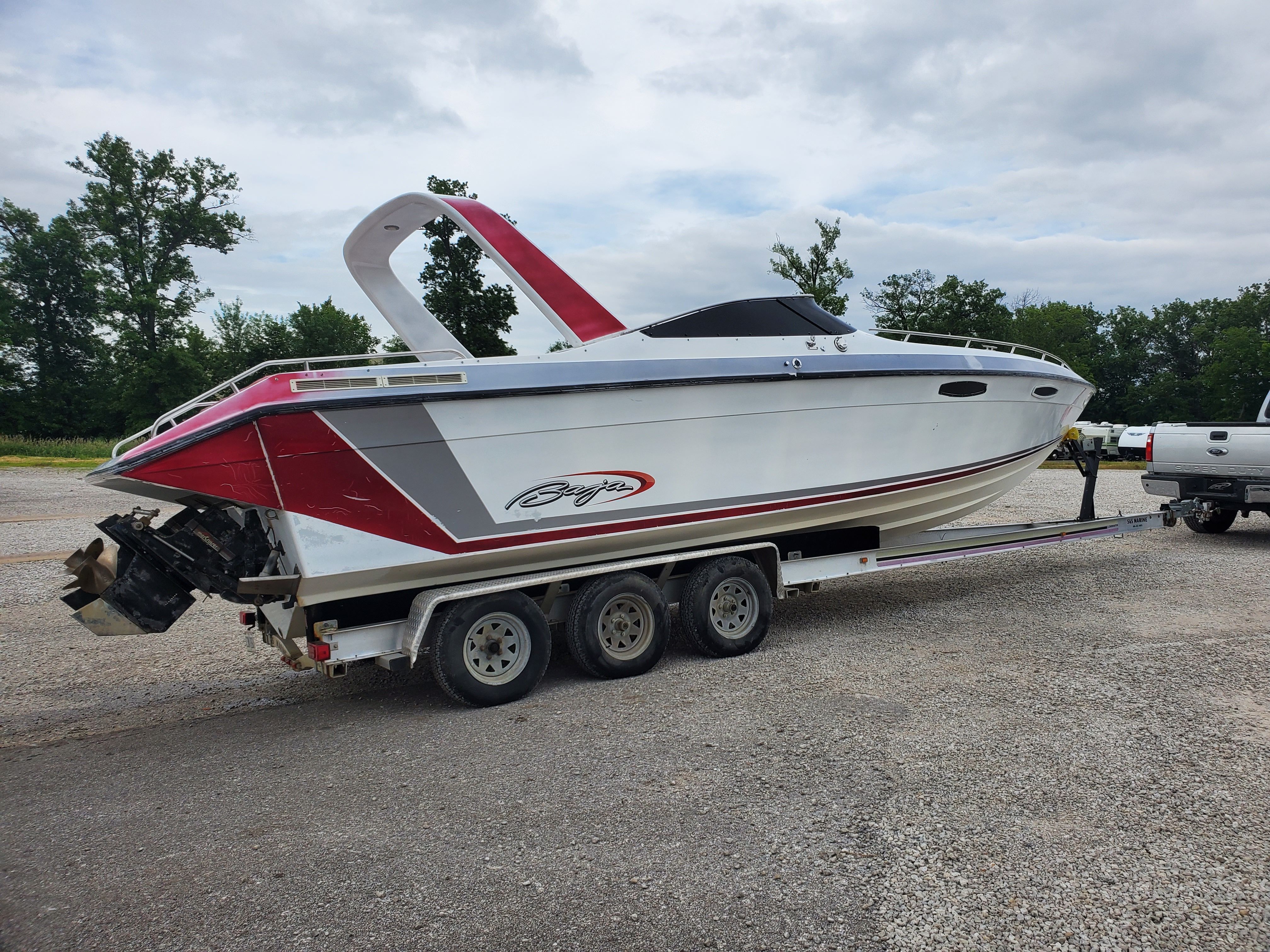 1989 Baja 280 Sport boat parked on trailer outdoors.