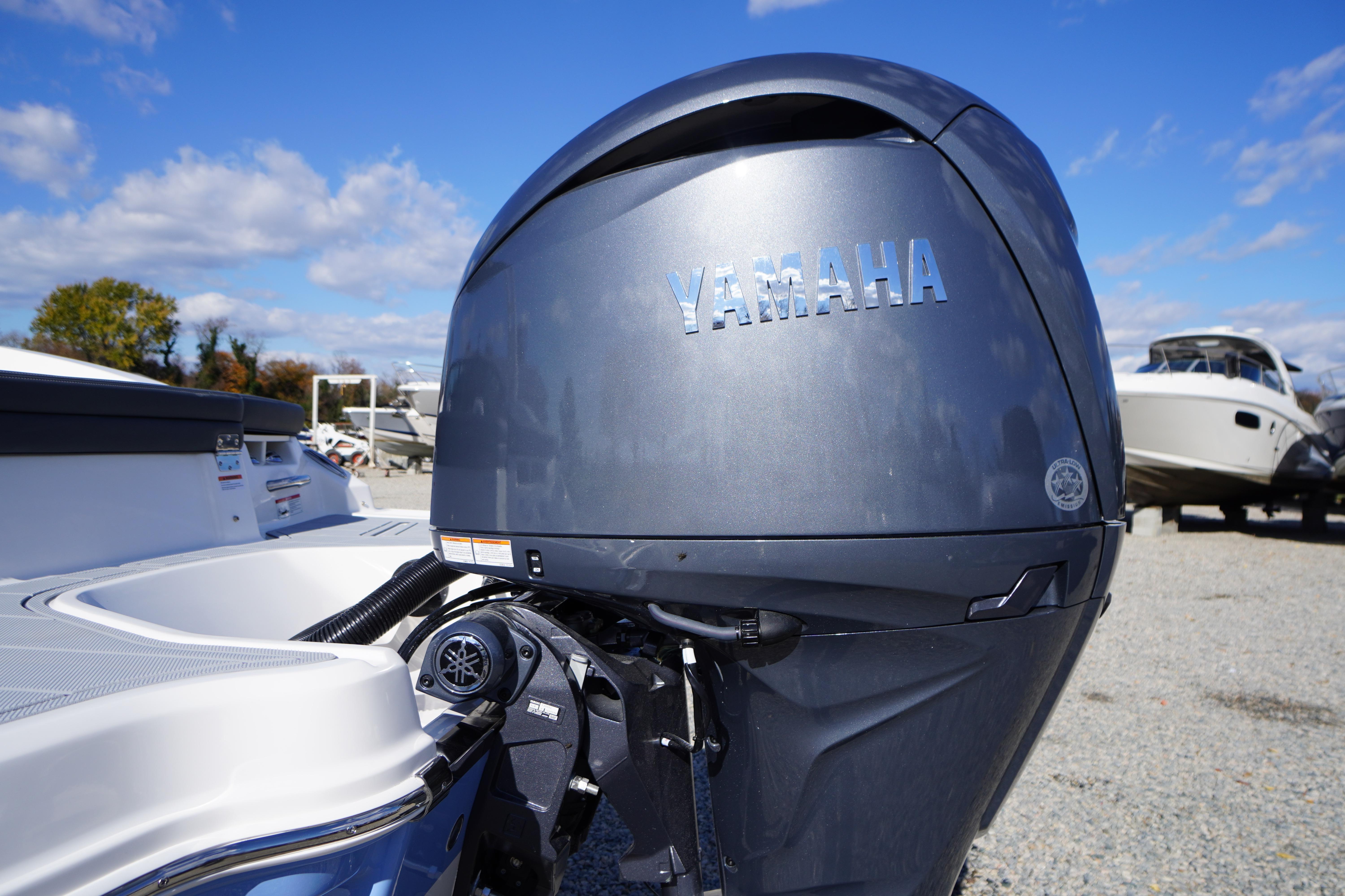 2026 Chaparral 23 SSi OB with Yamaha outboard motor, parked outdoors.