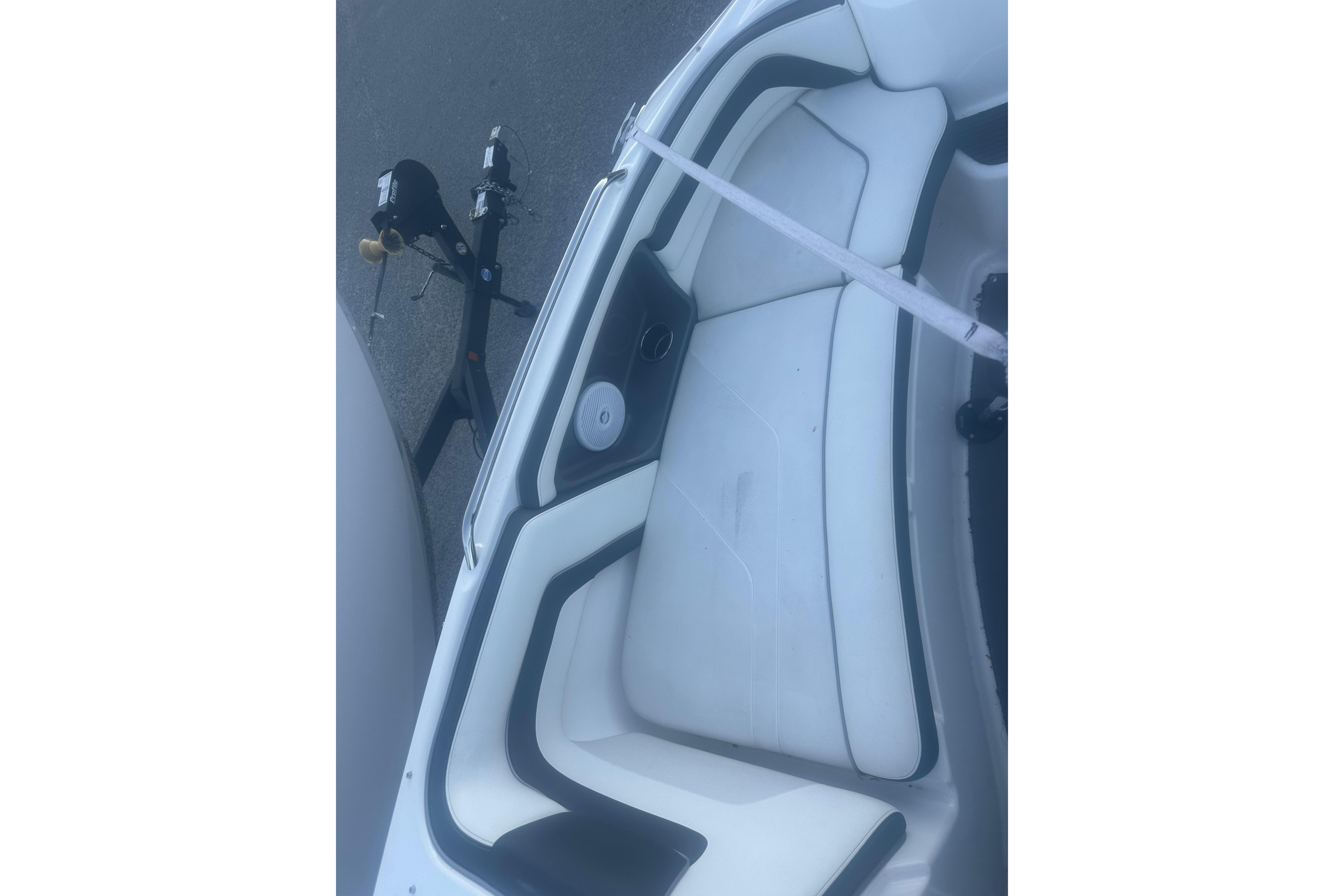 2015 Yamaha AR240 HO boat interior with white seating and trailer.