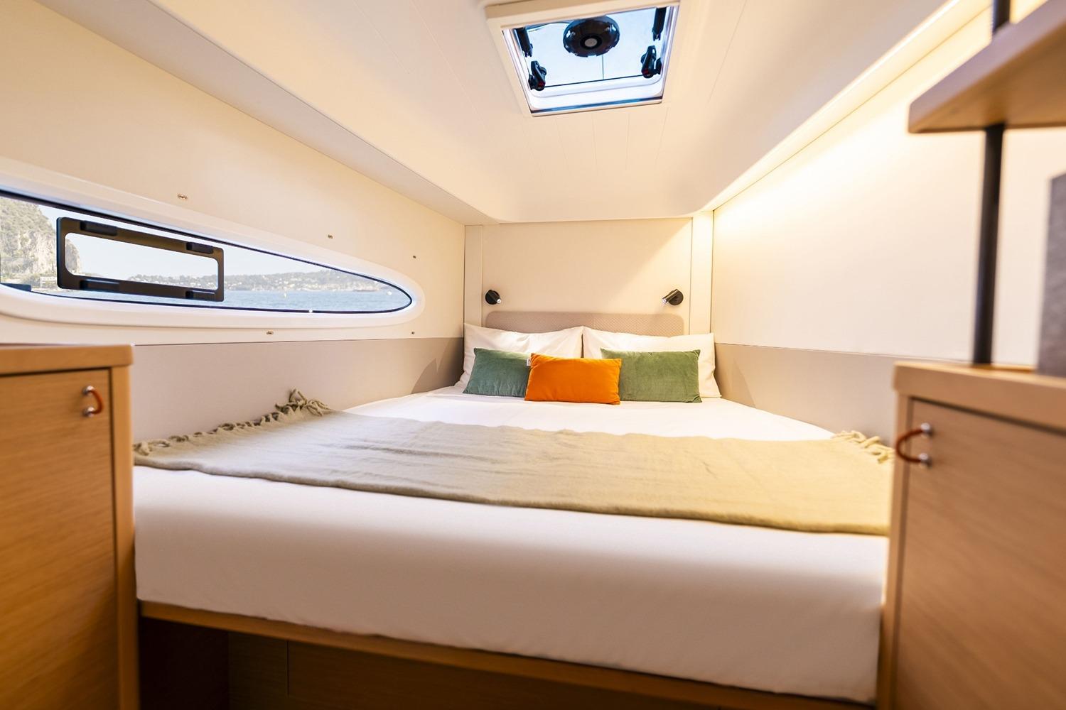 Manufacturer Provided Image: Luxurious cabin interior of 2026 Excess 13 yacht with cozy bedding and natural light.