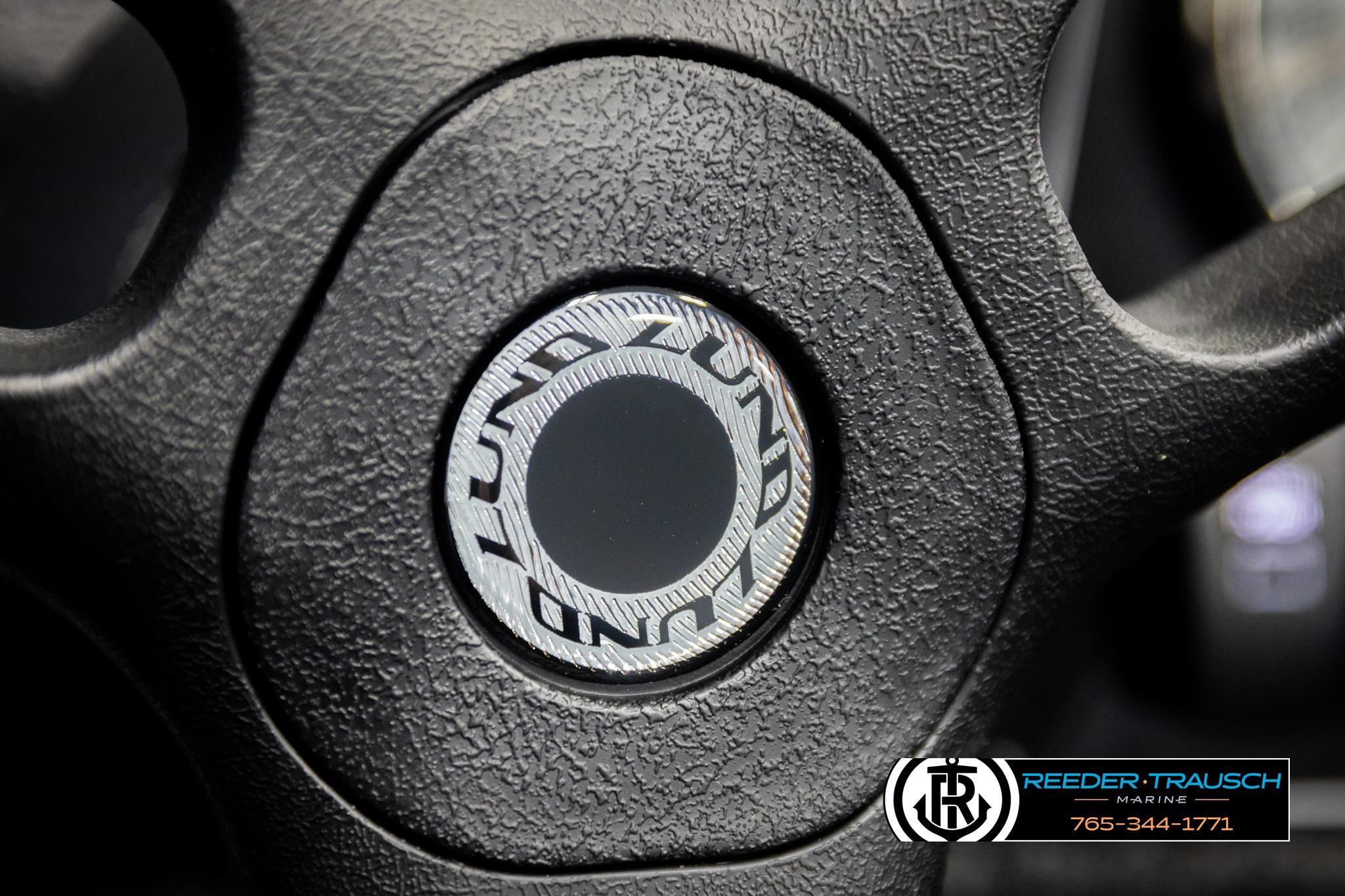 Steering wheel of 2026 Lund 1650 Rebel XL SS boat with logo detail.