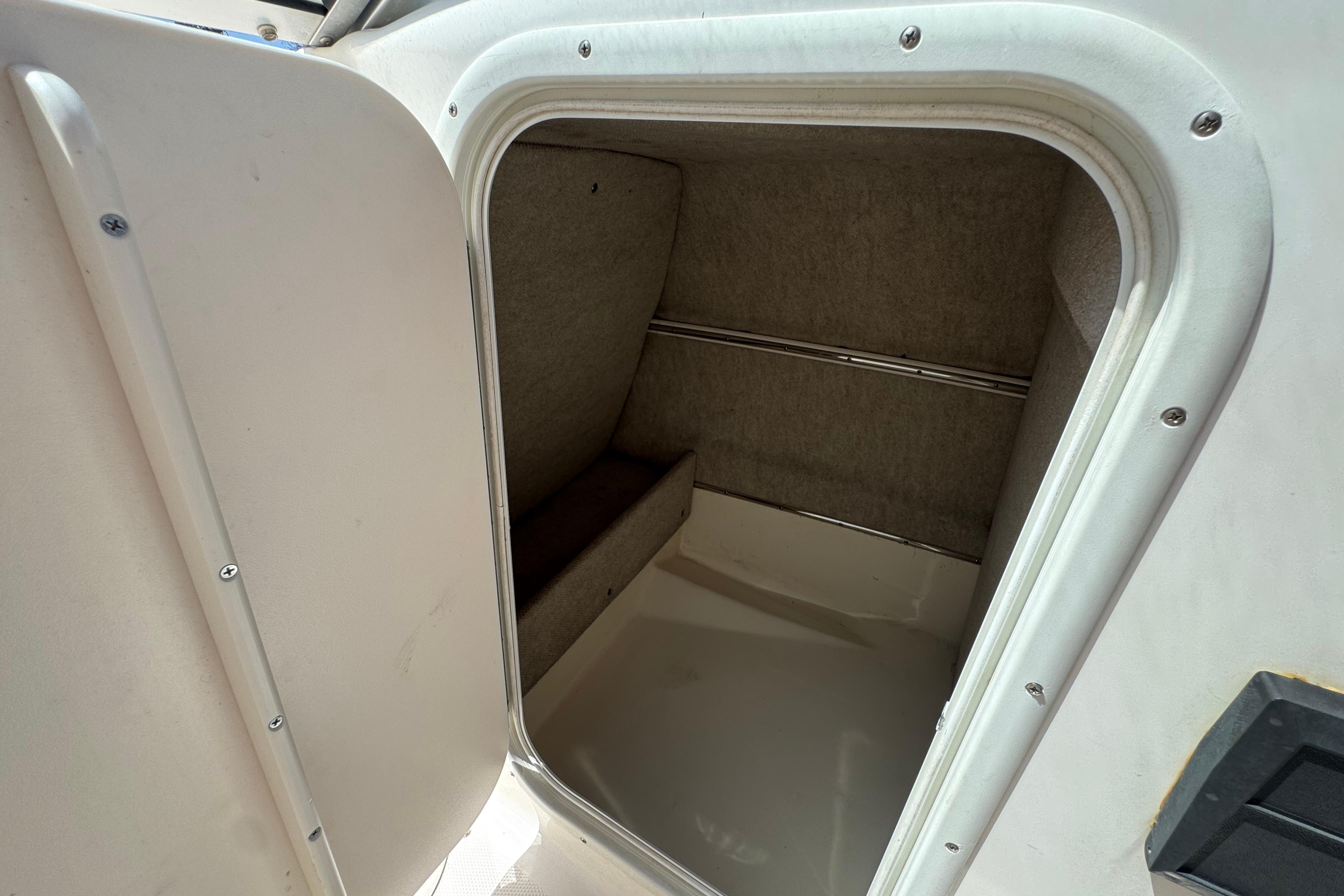 2010 Bryant 255 boat interior cabin with open door, showcasing compact space.