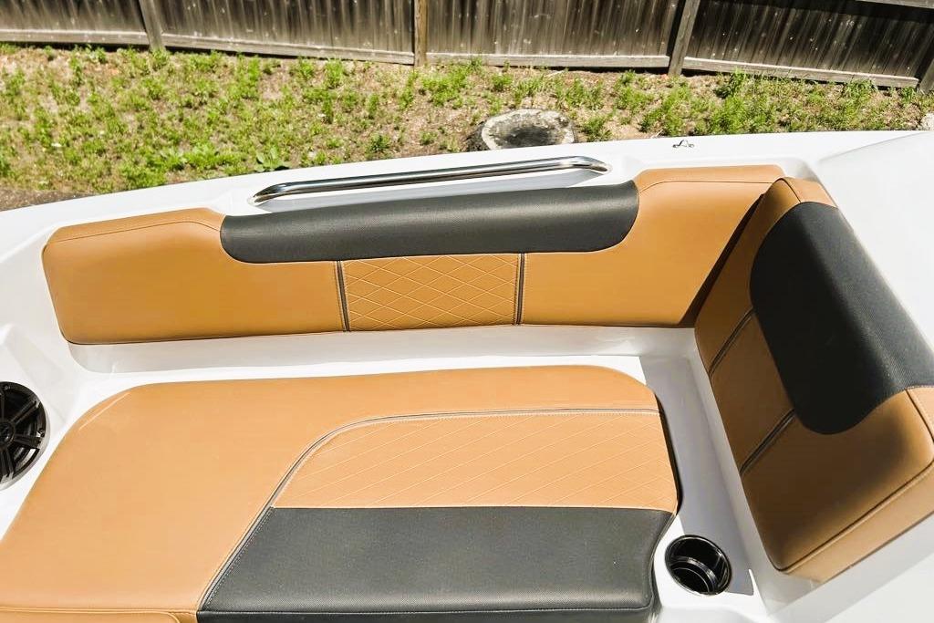 Luxurious seating on 2026 Tahoe 2150 boat with tan and black upholstery.