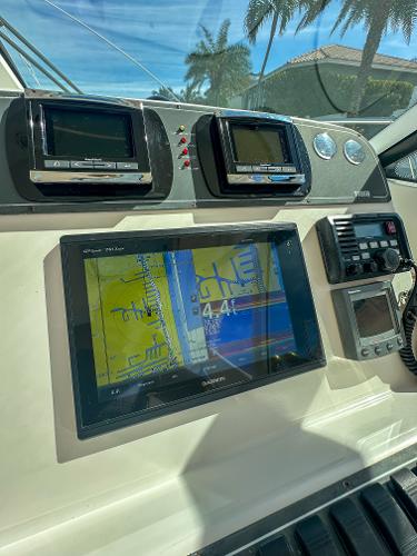 Control panel of a 2006 Tiara Yachts 3200 Open with navigation screens.