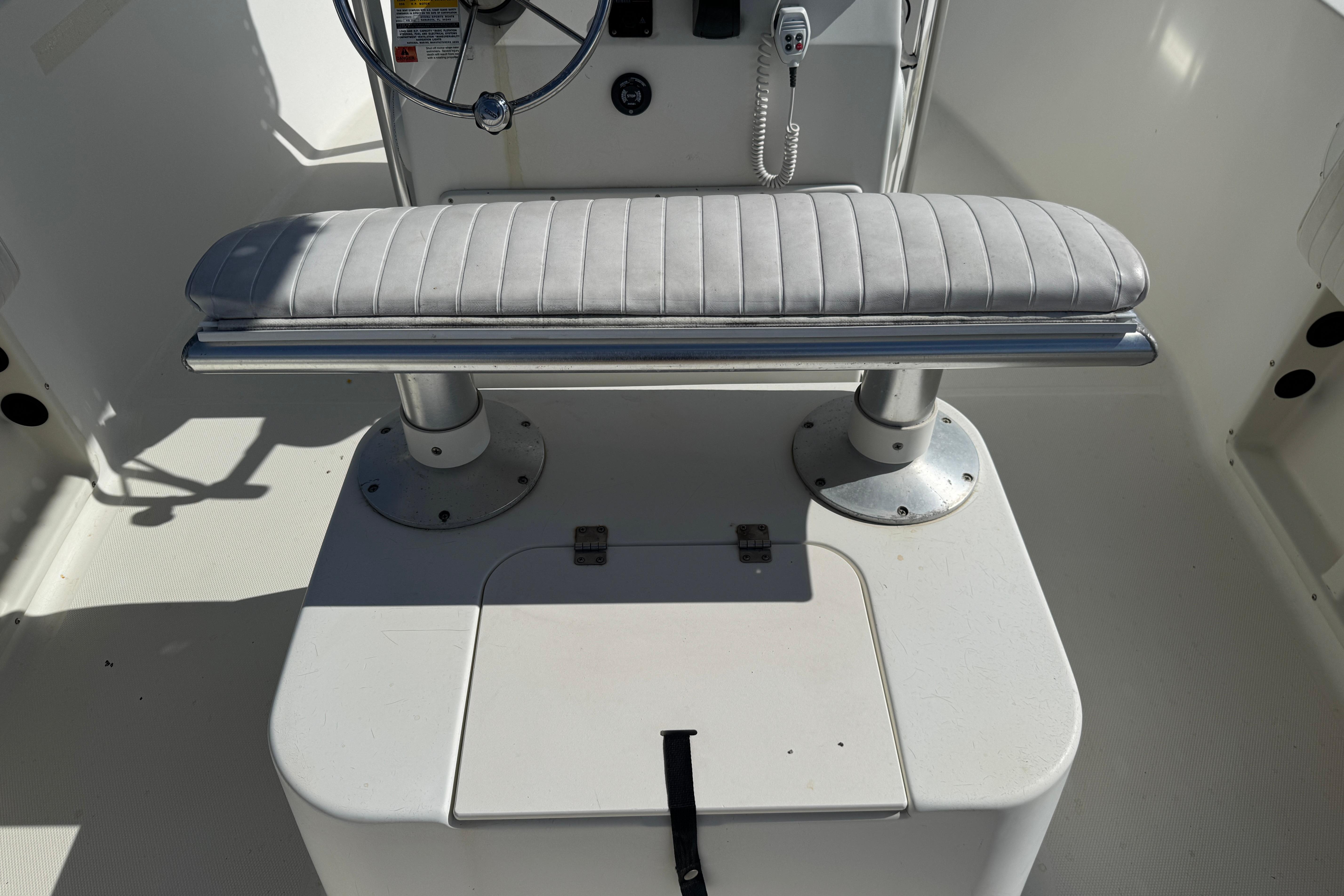 2002 Hydra-Sports 212 CC boat interior with steering wheel and cushioned seat.