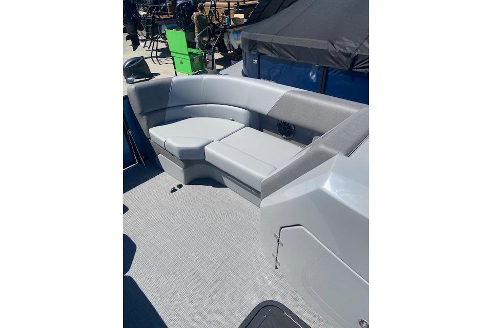 2026 Manitou 23 AURORA RF VPII 575 boat interior with gray seating and speaker.