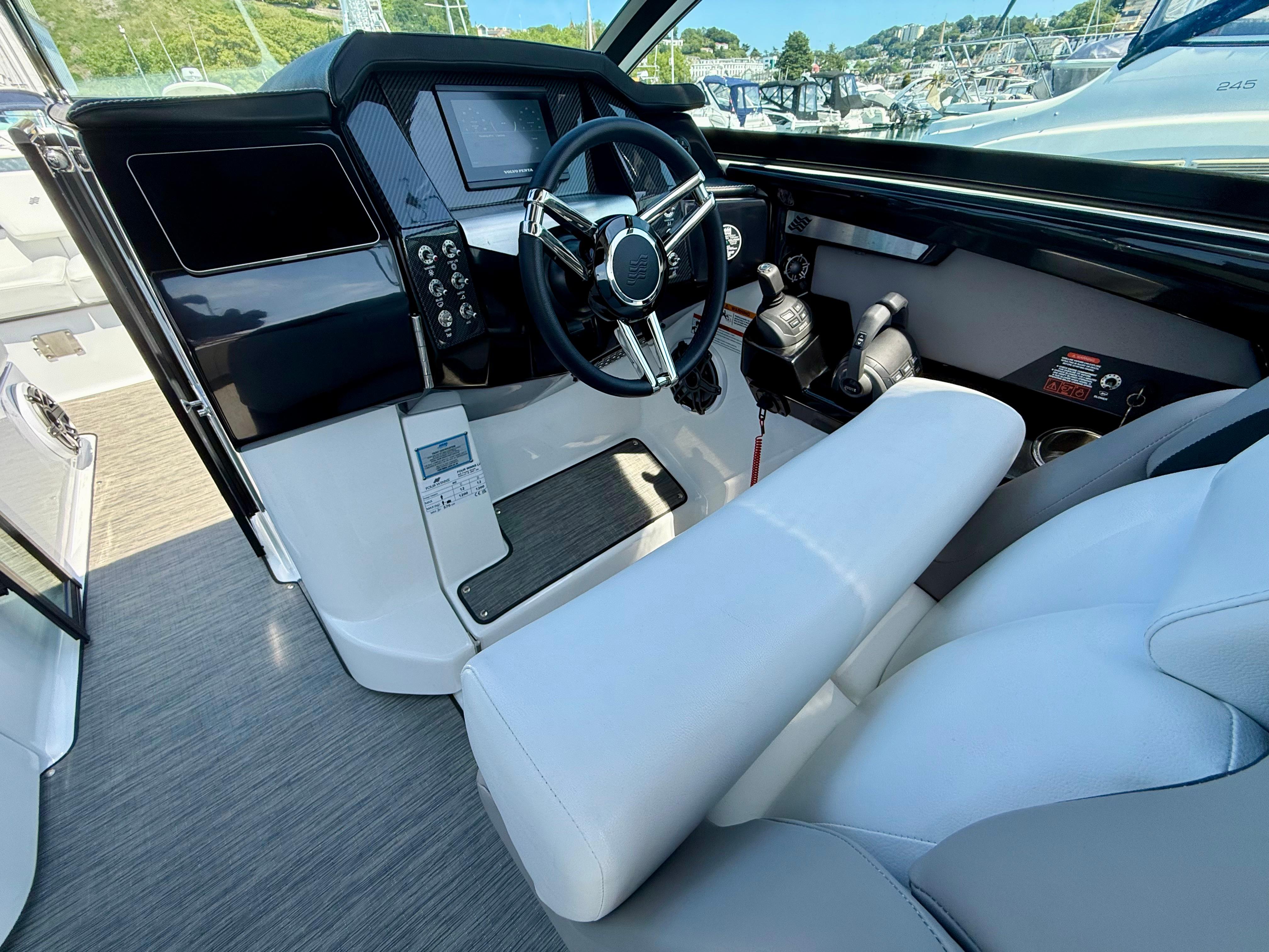 2023 Four Winns H290 boat cockpit with modern steering and controls.