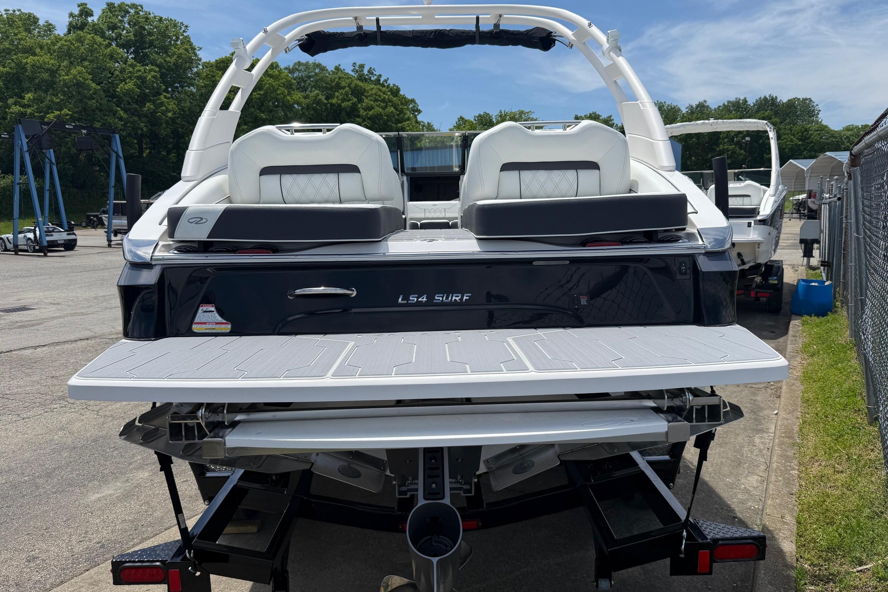 2026 Regal LS4 Surf boat rear view, featuring sleek design and spacious swim platform.