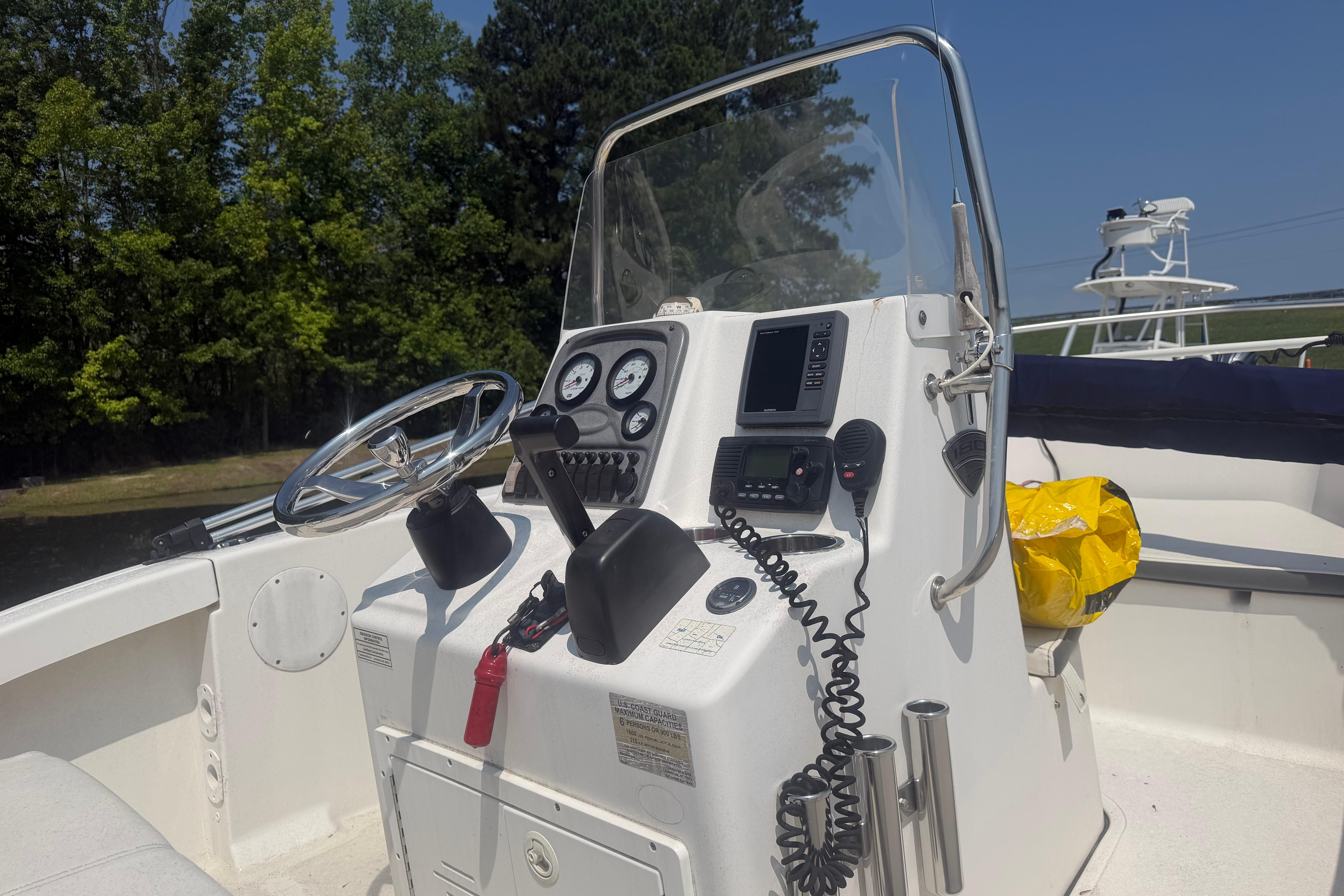 2015 Tidewater 180 CC Adventure boat console with steering wheel and navigation equipment.