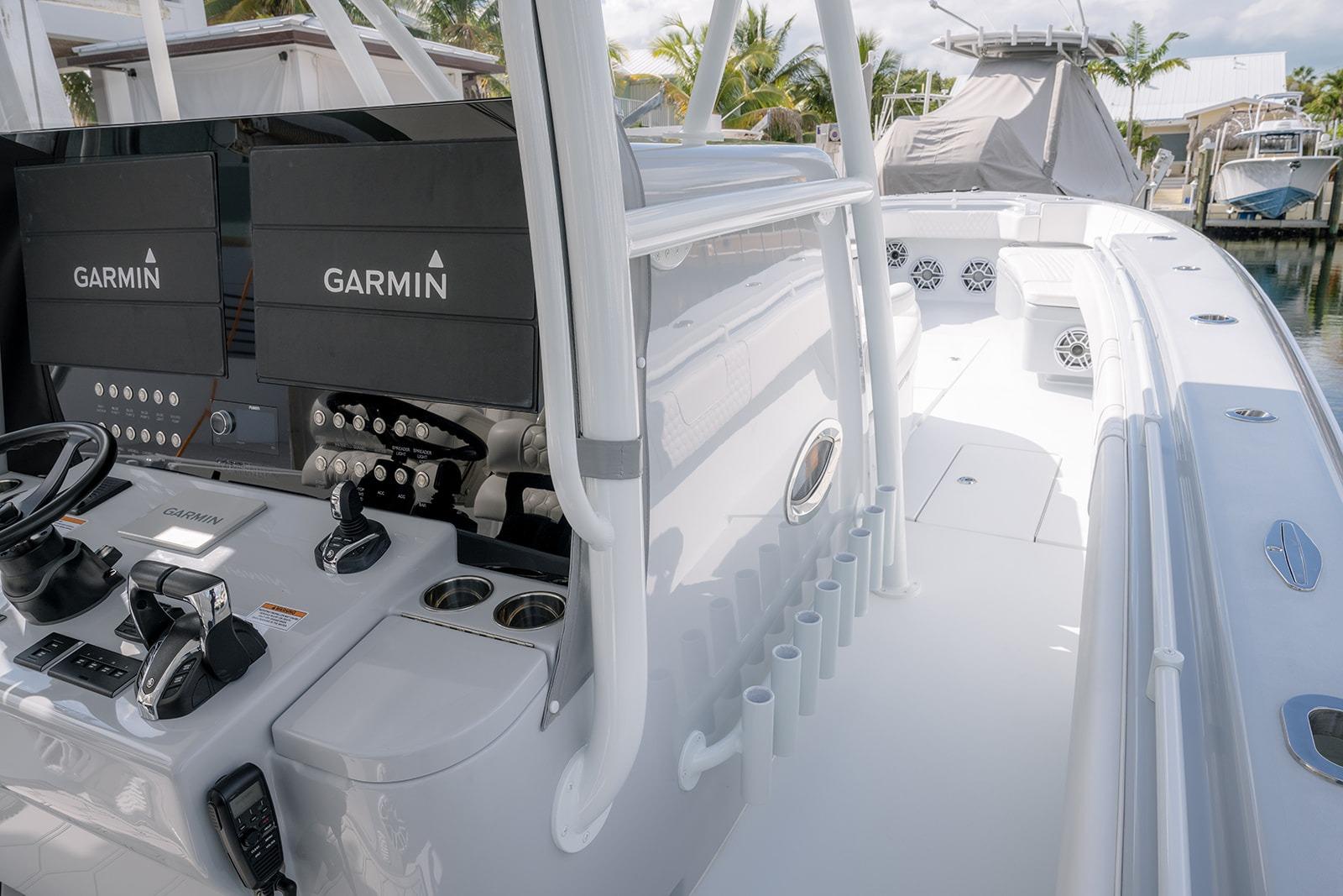 2024 Contender 44 ST boat with Garmin navigation, sleek white interior, and modern controls.