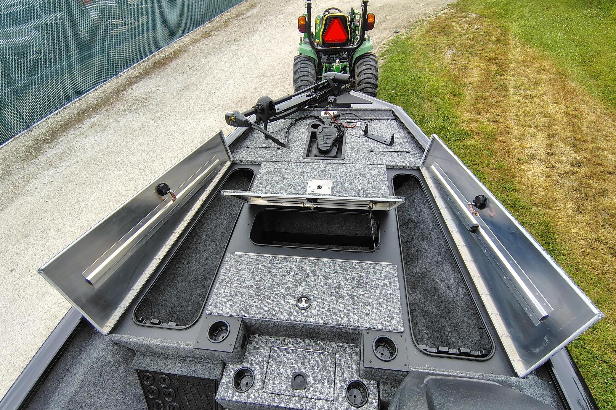 2026 Tracker Pro Team 195 boat interior with open storage compartments and fishing gear.