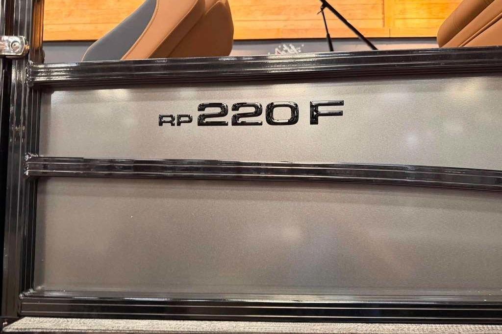 2026 Ranger 220F model nameplate on a metallic surface with seating in the background.