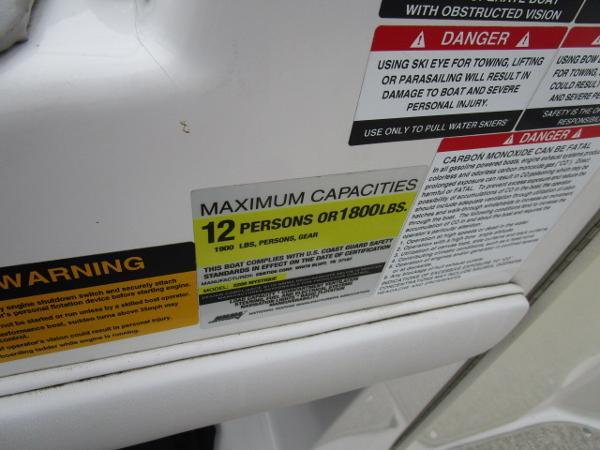 Capacity warning label on 2004 Ebbtide 22 Mystique boat, maximum 12 persons or 1800 lbs.