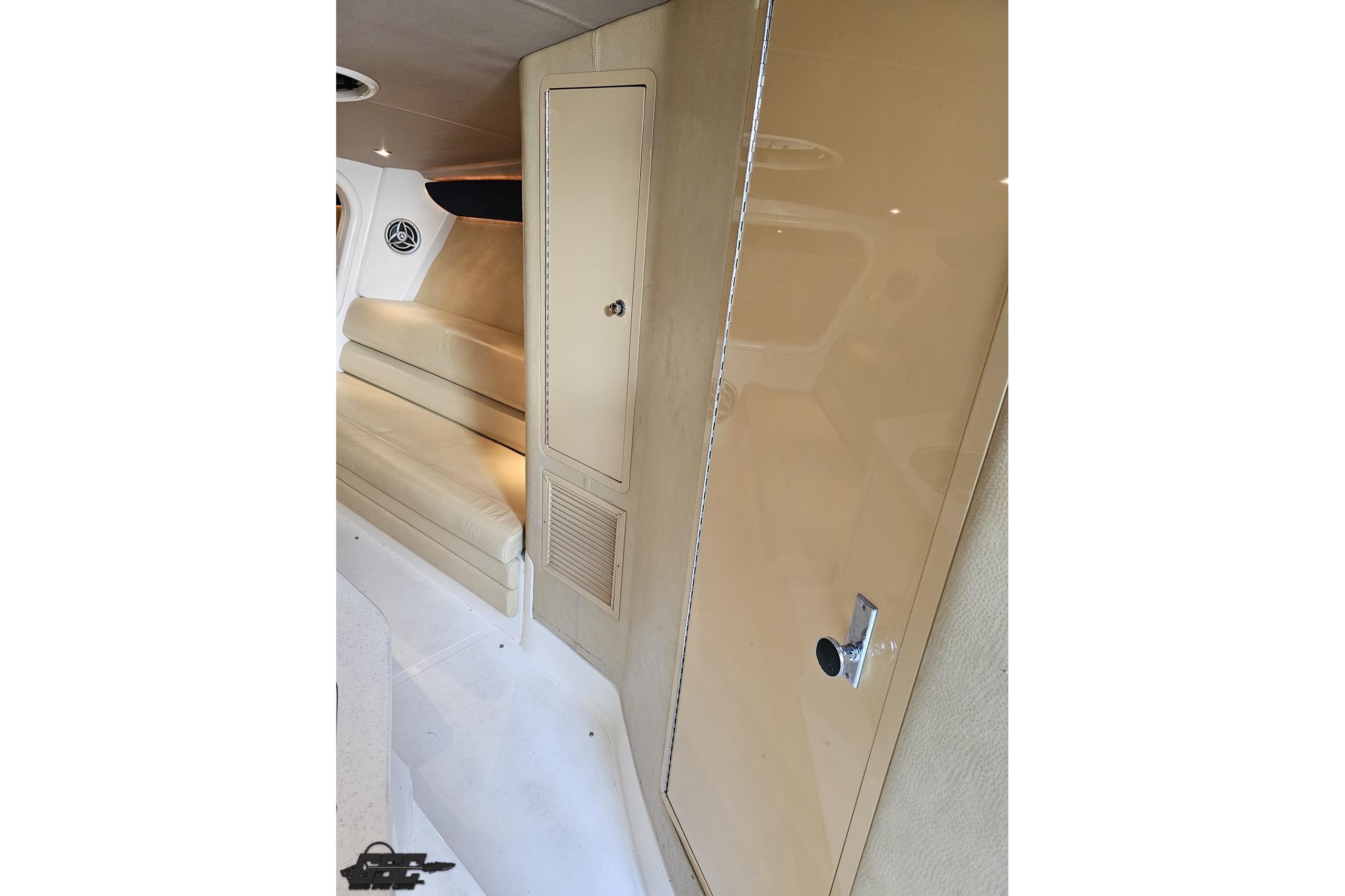 2007 Hustler 41 Razor interior with beige seating and storage cabinet.
