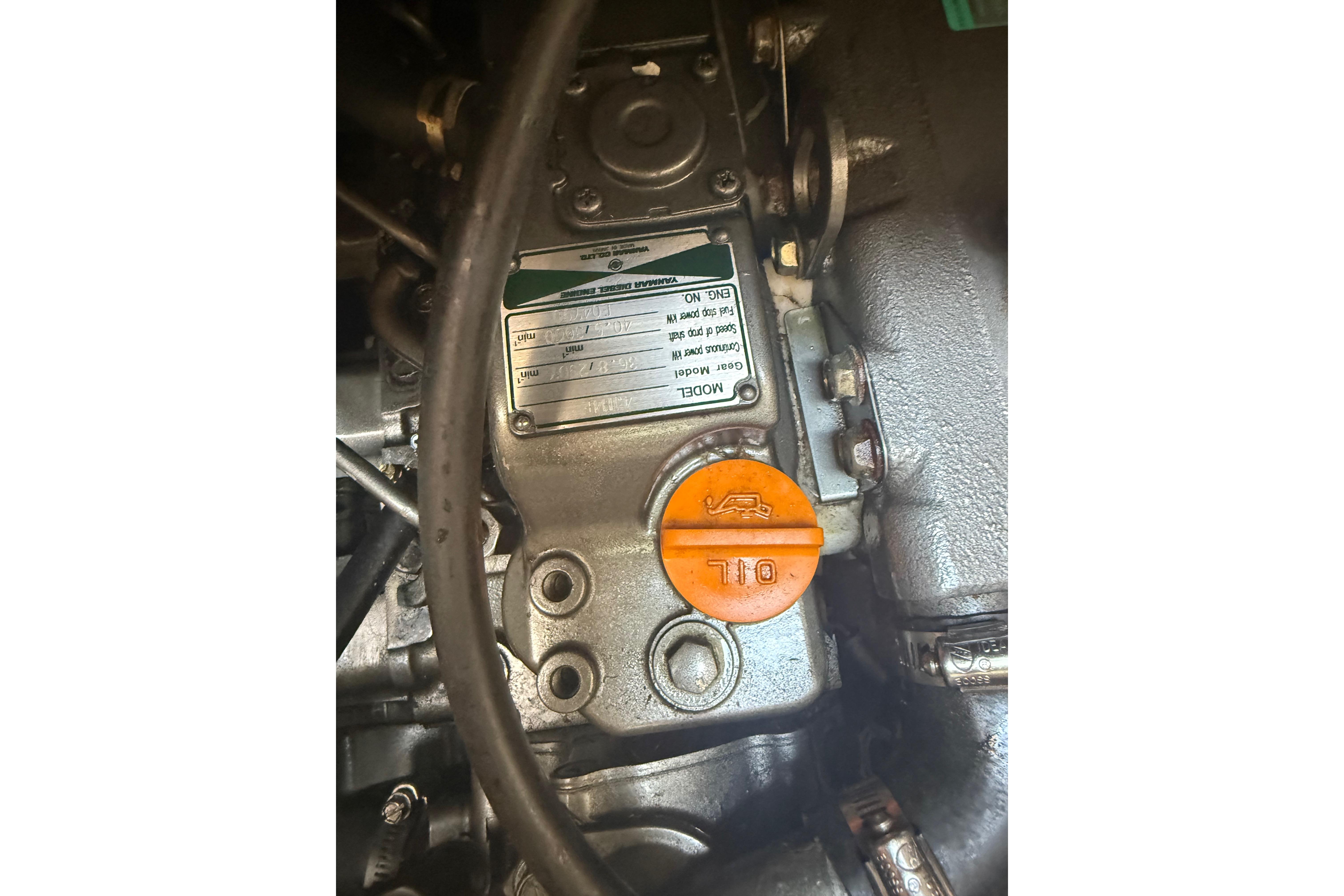 Engine compartment of a 2007 Hunter 41 Deck Salon sailboat, featuring an oil cap.