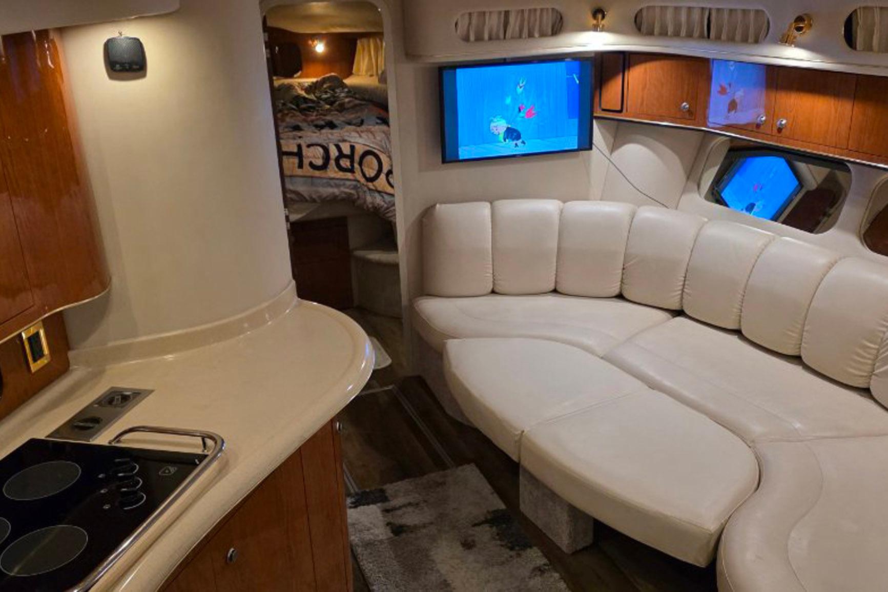 Luxurious interior of 1998 Sea Ray Sundancer 400 with white leather seating and modern amenities.