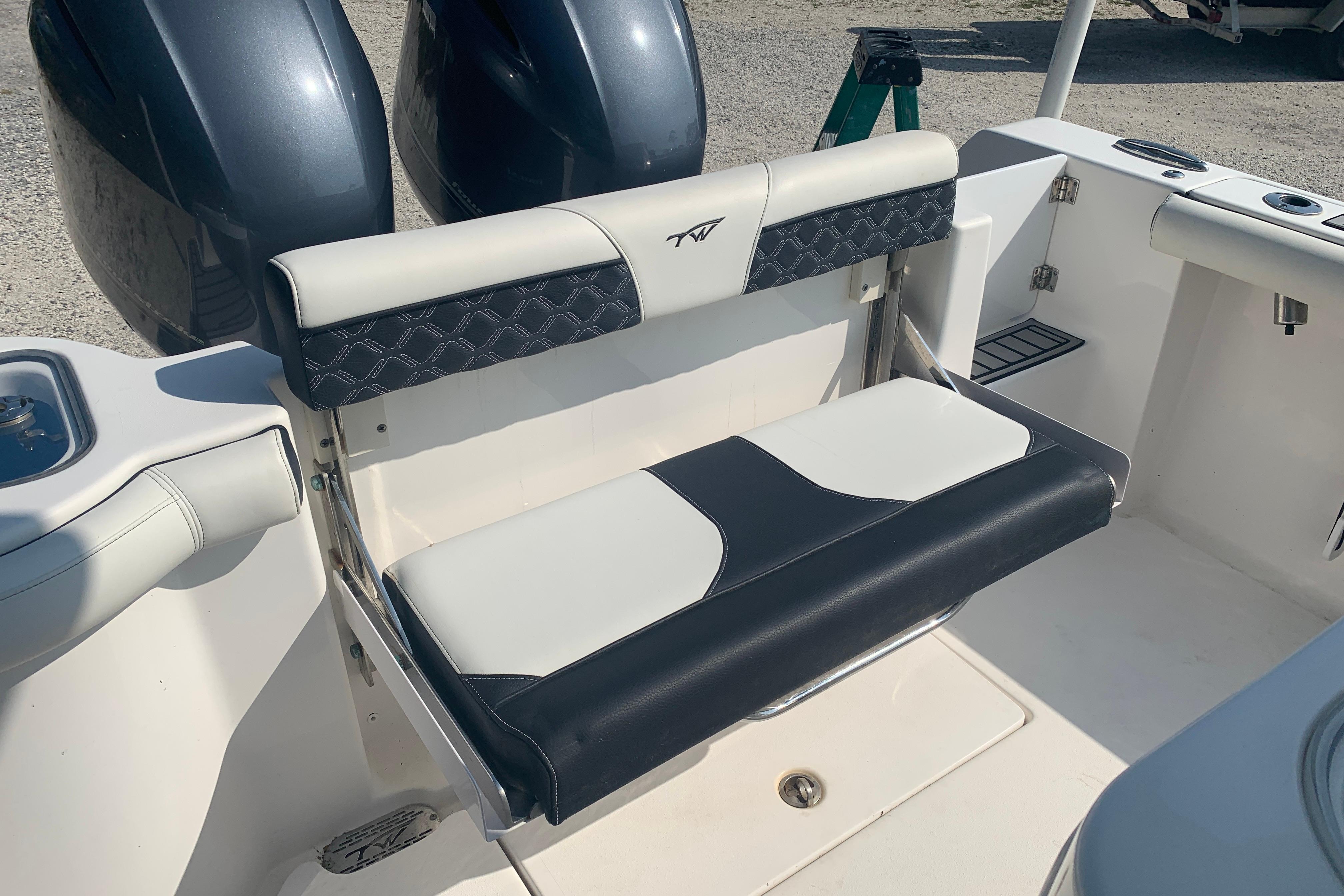 2021 Tidewater 256 CC Adventure boat seat with dual engines in the background.