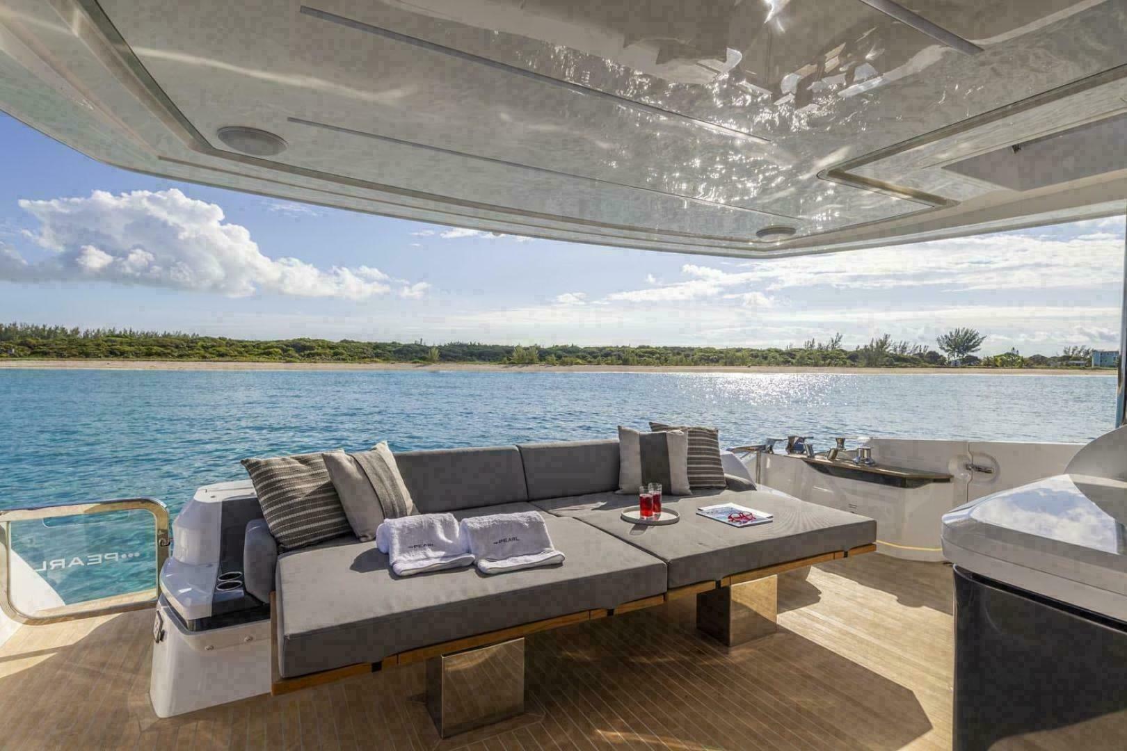 Luxurious Pearl 72 yacht deck with comfortable seating, overlooking serene blue waters, 2023 model.