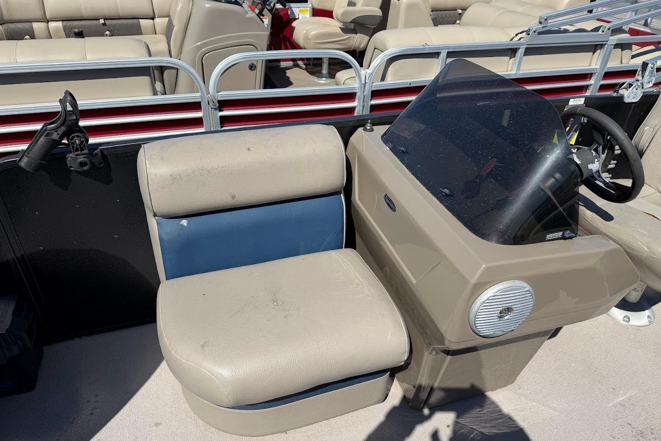 2013 Premier 221 Explorer boat interior with beige seating and steering console.
