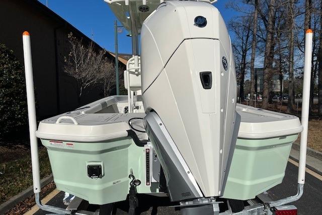 2026 Mako 24 APEX boat with powerful outboard motor, parked outdoors.