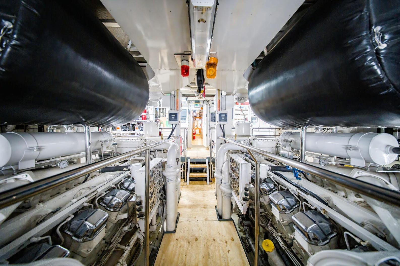 Engine room of 1988 Feadship Twin Screw Diesel Yacht, showcasing machinery and equipment.
