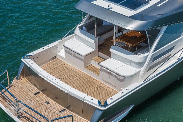 2025 Riviera 645 SUV luxury yacht with spacious deck and seating area.