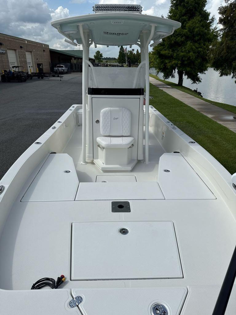 2025 Ranger 2360 Bay boat, white deck, center console, parked near water.