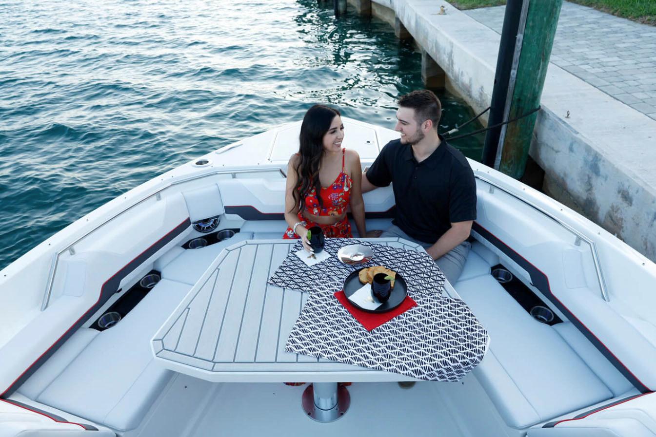 Manufacturer Provided Image: Couple dining on a 2023 Formula 387 Center Console Sport boat.