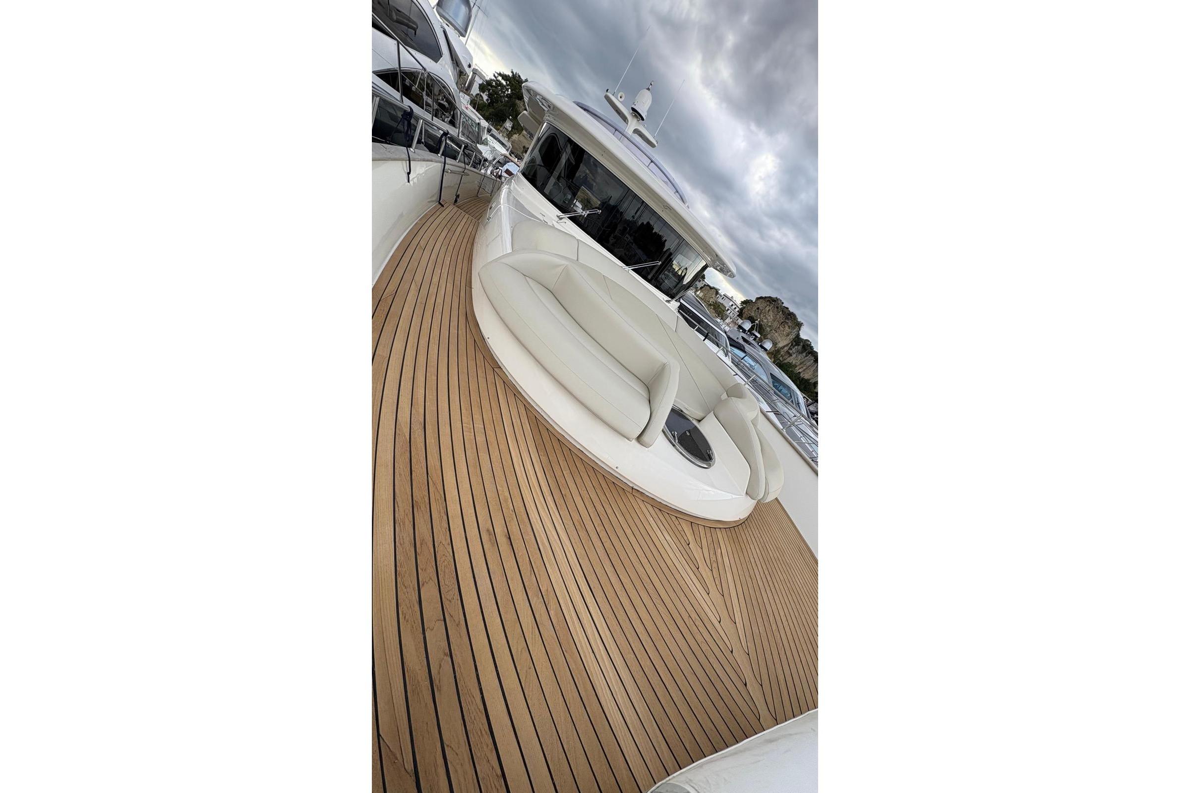2008 Apreamare Maestro 65 yacht with sleek wooden deck and elegant seating area.