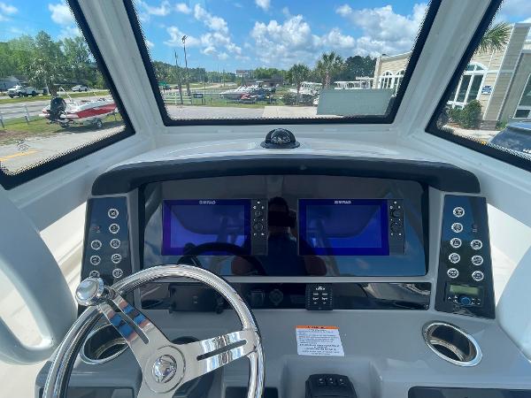2023 Robalo R270 boat dashboard with dual Simrad displays and steering wheel.