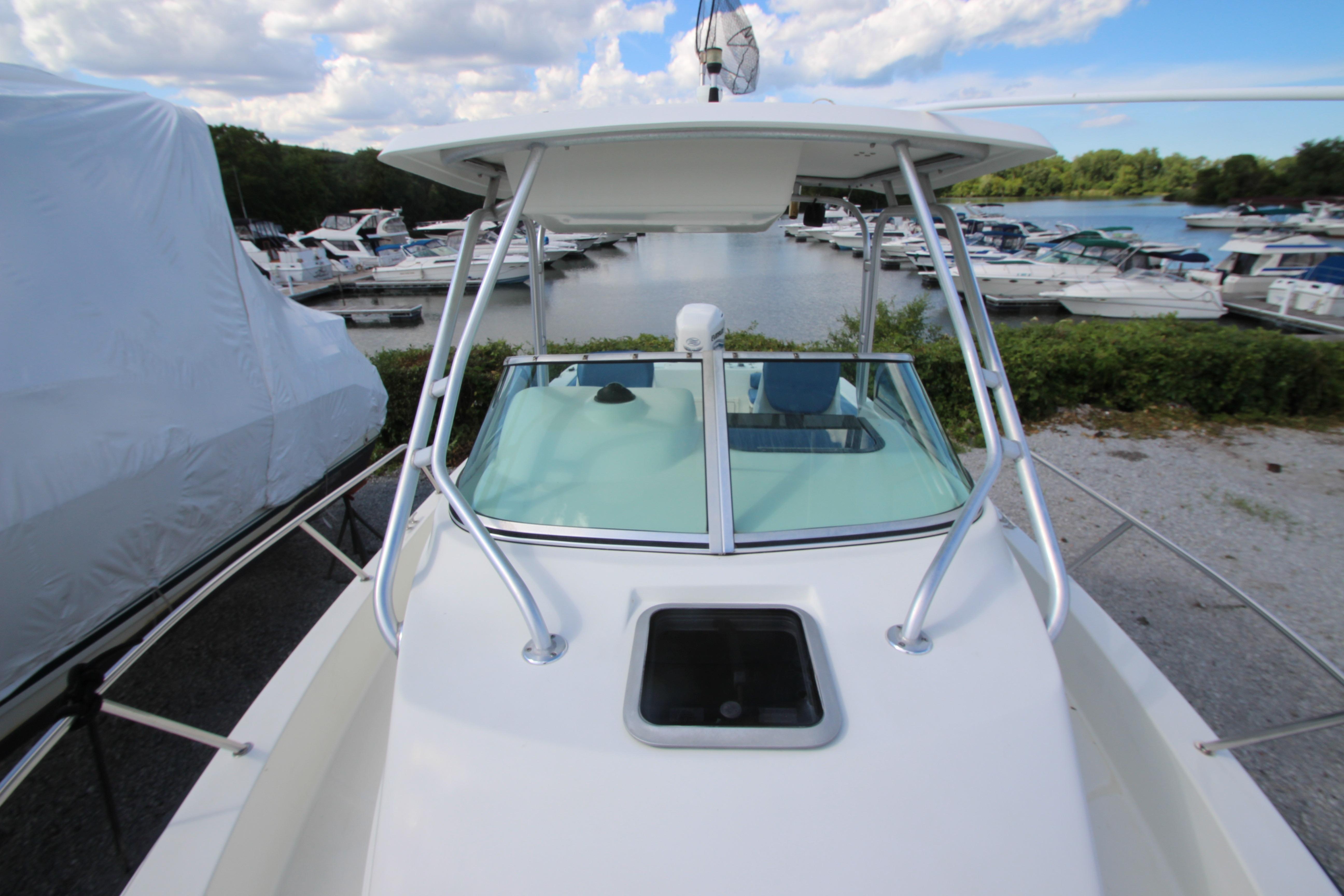 2002 Hydra-Sports 230 WA boat docked at marina with clear sky and water view.