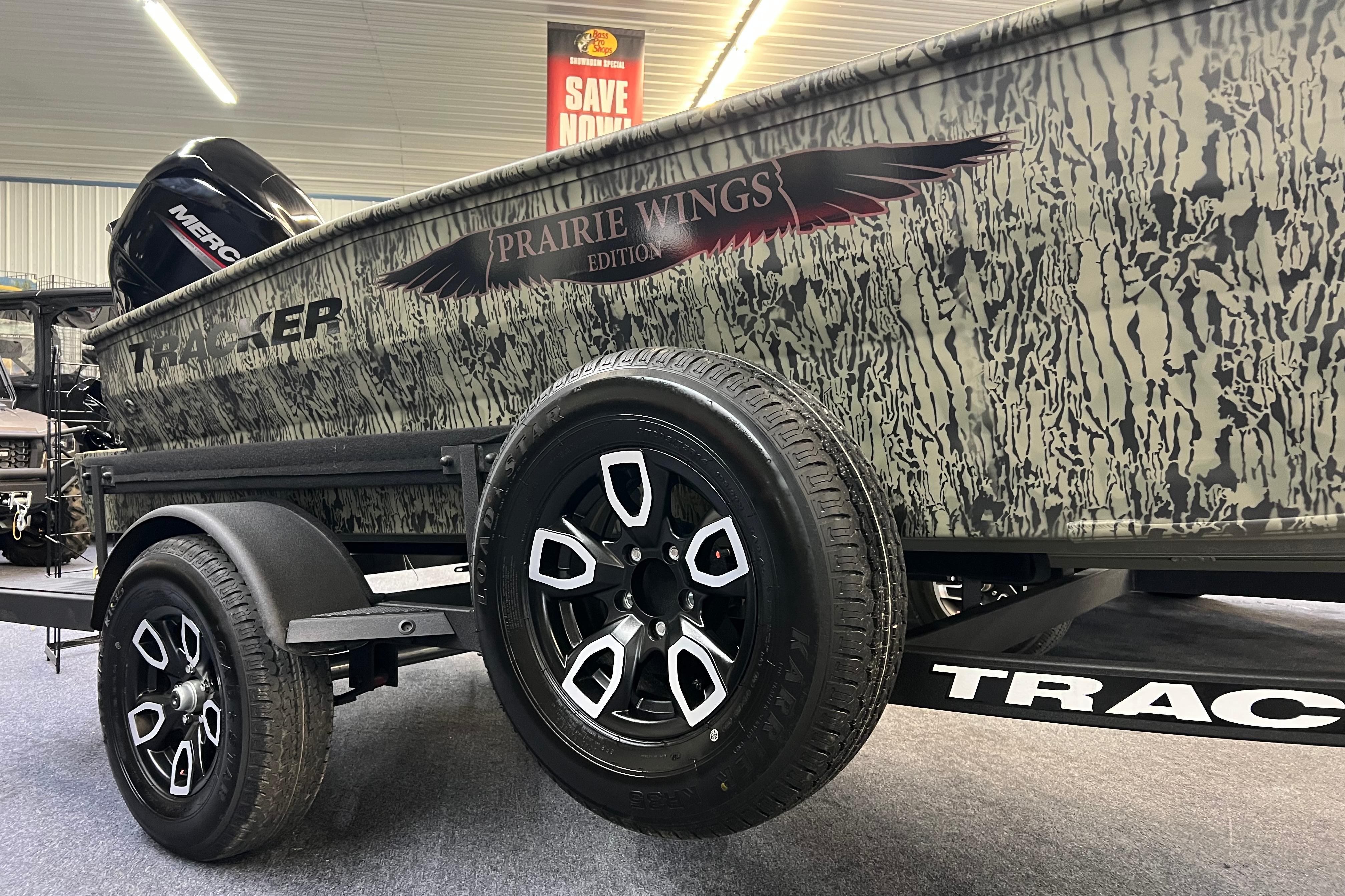 2026 Tracker Grizzly 1650 T Prairie Wings Edition boat on trailer, camo design.