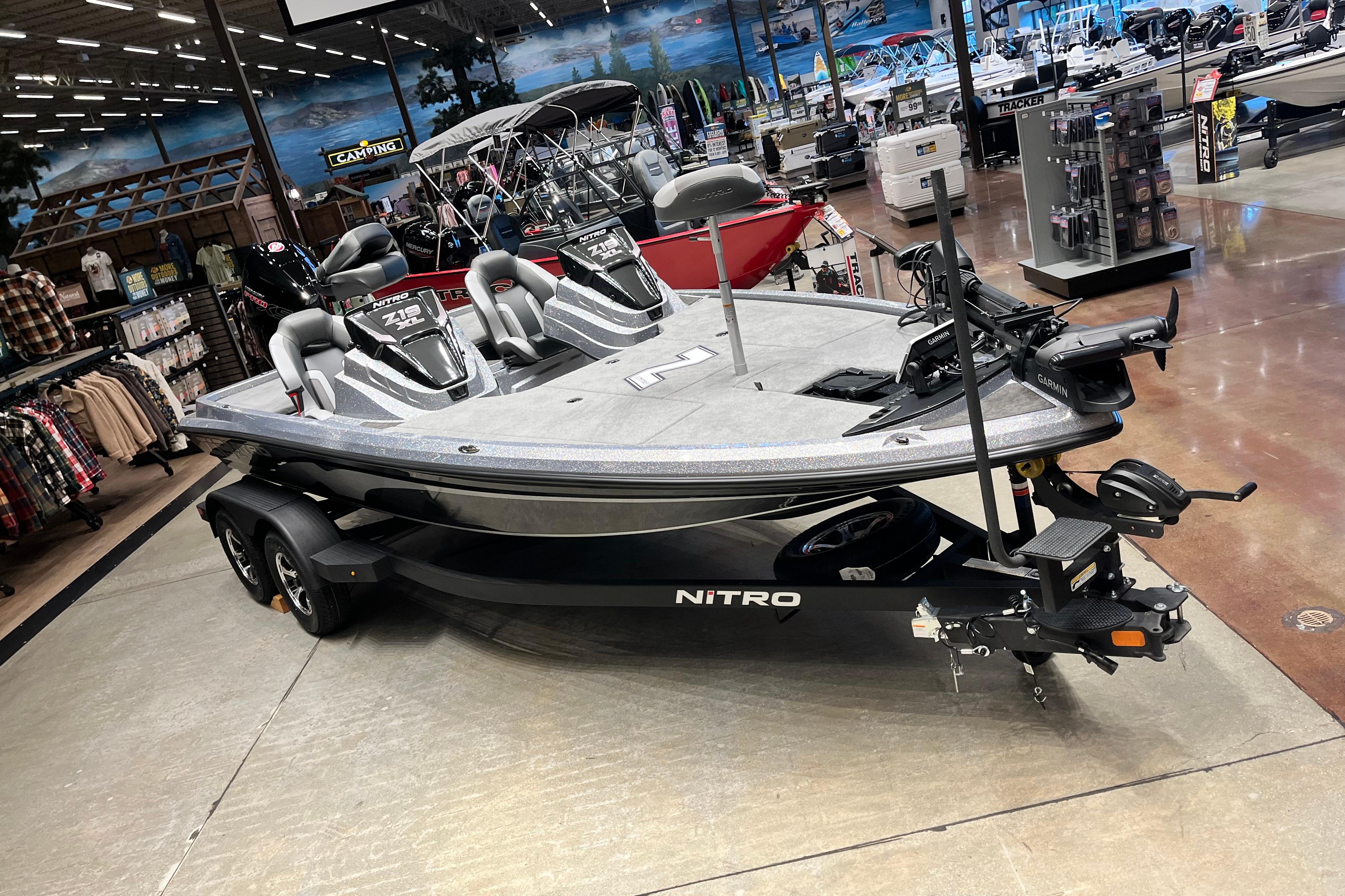2026 Nitro Z19 XL Pro boat displayed in a showroom with fishing gear.