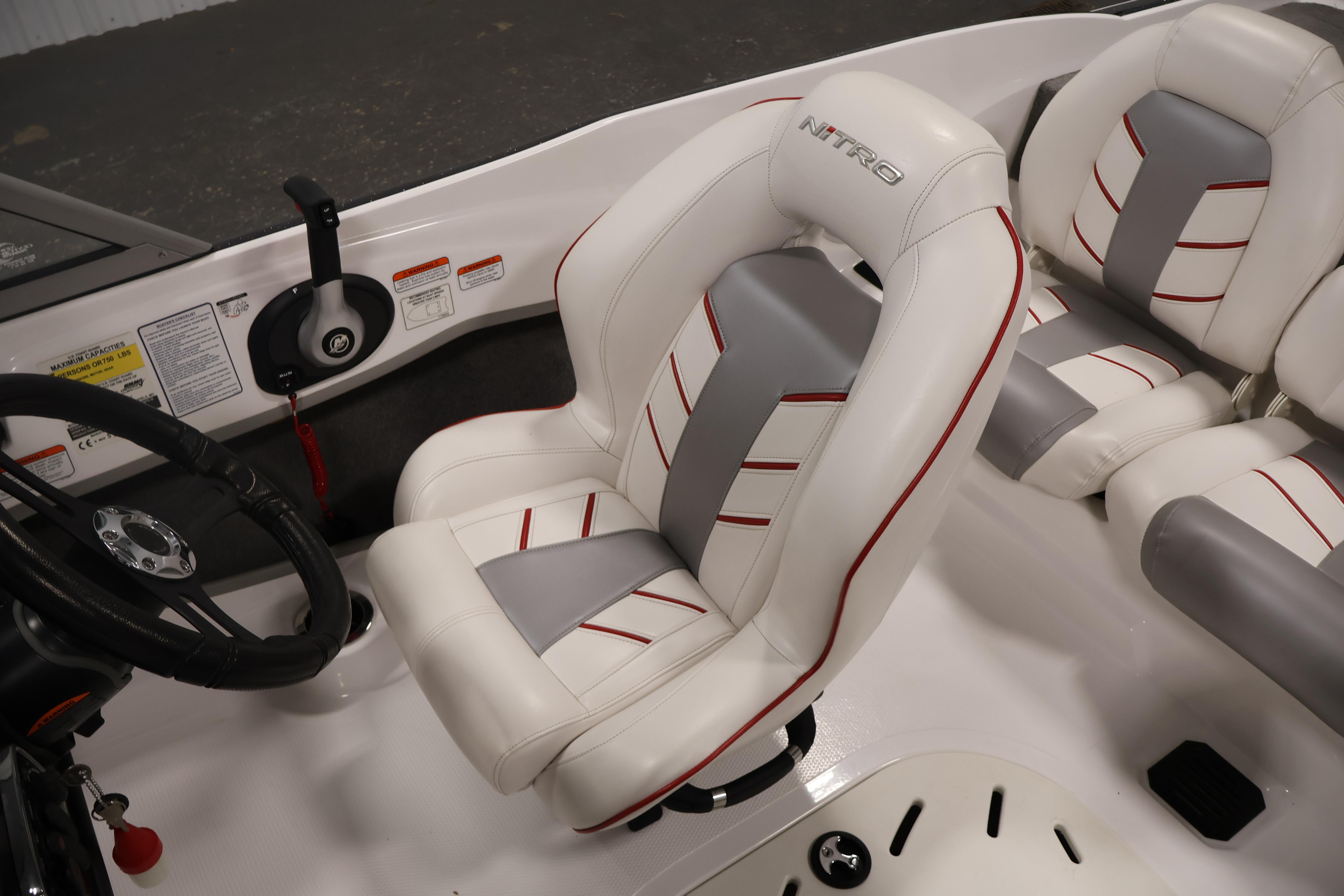 2019 Nitro Z19 Sport boat interior with white and gray seating, steering wheel, and controls.