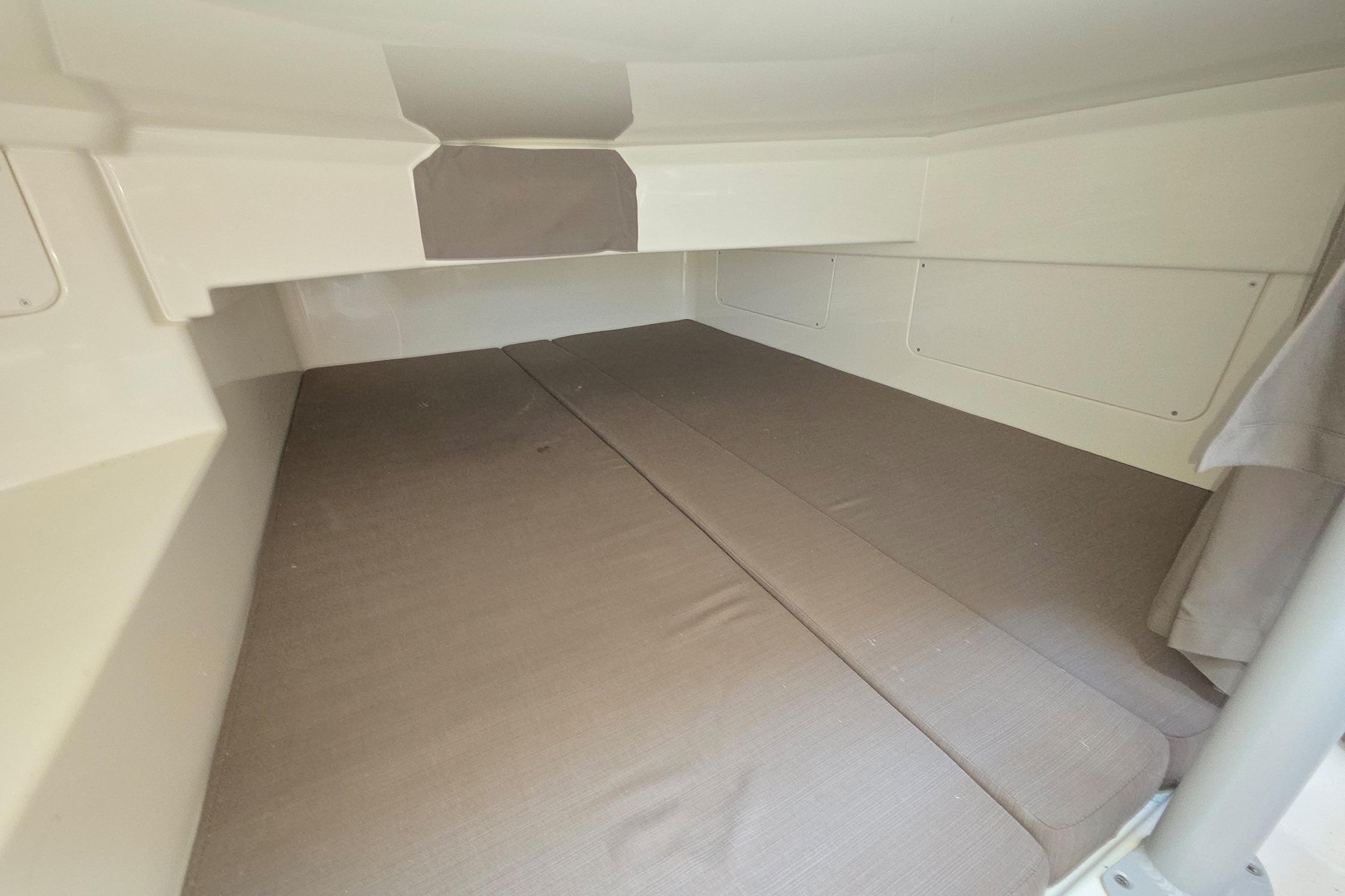 Interior cabin of 2017 Quicksilver Activ 805 Cruiser with beige bedding.