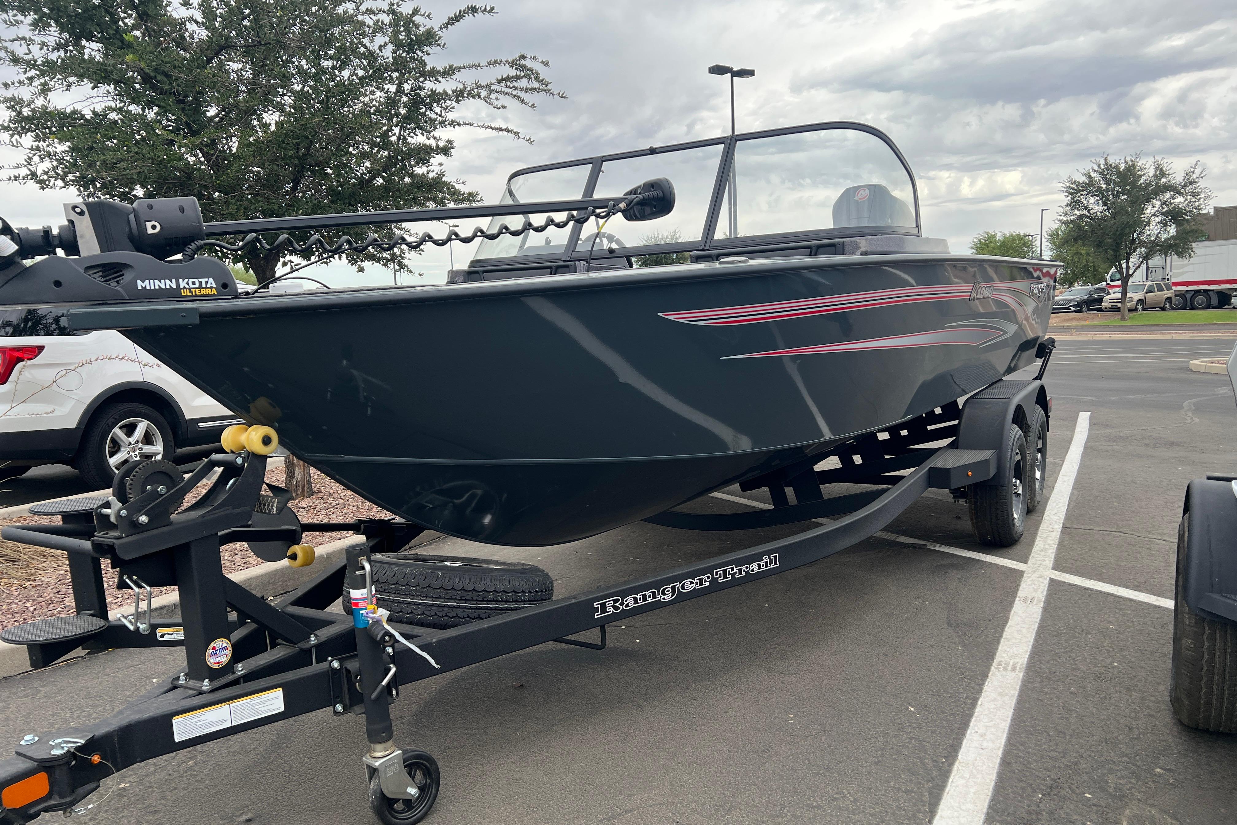2026 Ranger VX1988 WT boat on trailer in parking lot, featuring Minn Kota motor.