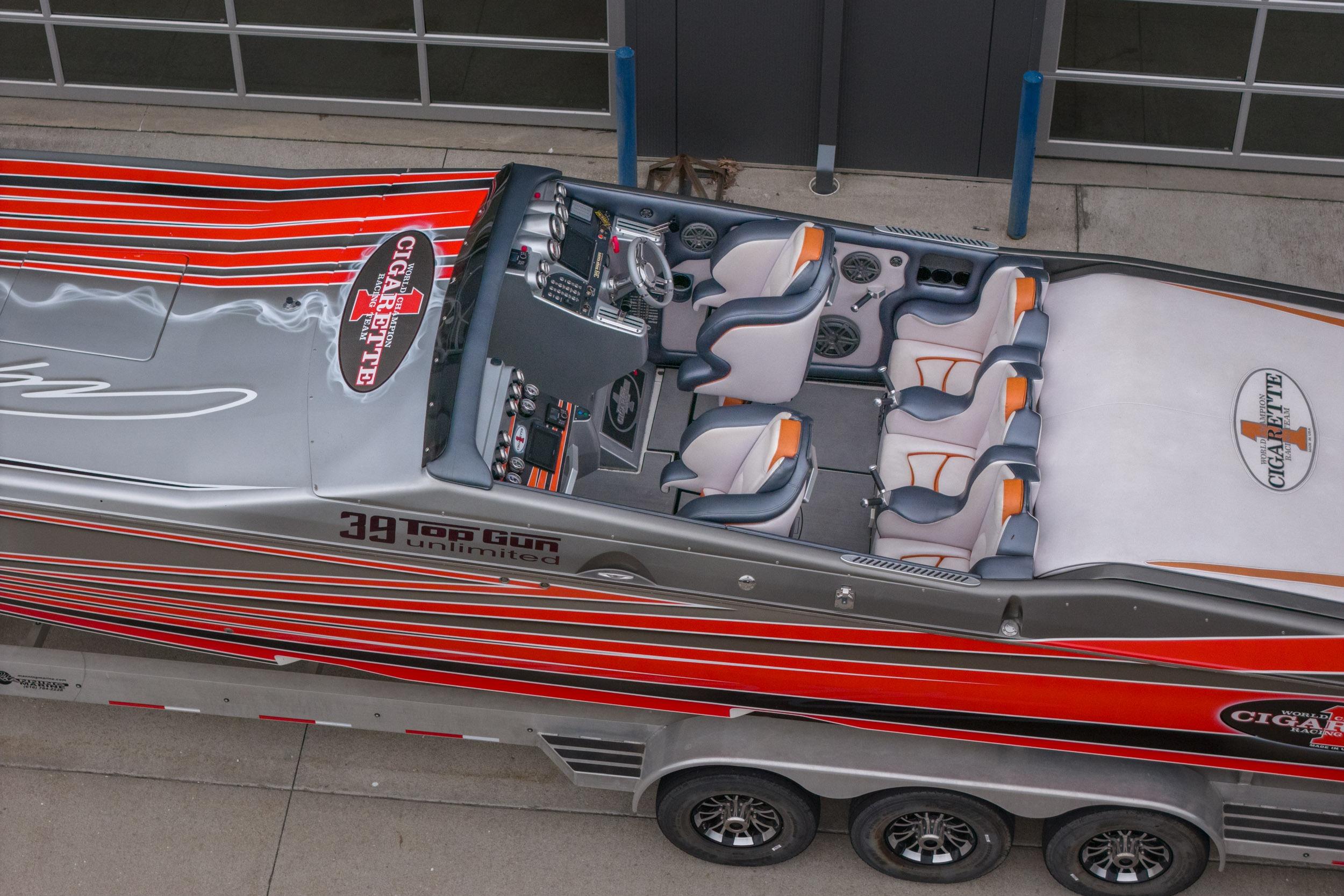 2006 Cigarette 39' Top Gun Unlimited boat with sleek design and vibrant red stripes.